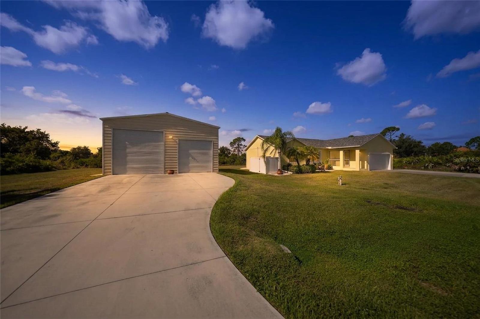 Experience the freedom of space and privacy at 12117 Ashley Ave! Located in the waterfront community of Gulf Cove, this well-maintained home stands out with a double lot, hurricane-impact windows and doors, a whole-home reverse osmosis system, newer roof, attached 2-car garage, and an impressive detached 31x38 insulated metal-frame garage with both a 12-foot roll-up door and a 10-foot roll-up door. Designed with warm coastal colors, cathedral ceilings, and an open split-bedroom floor plan, the home offers a comfortable layout with 3 bedrooms, 2 bathrooms, and inviting indoor-outdoor living. The kitchen features granite countertops, wood cabinets, stainless steel appliances, a tile backsplash, and a breakfast bar that opens to the main living area, creating an easy flow for everyday living and entertaining. The spacious primary bedroom includes a large walk-in closet and an ensuite bathroom with a walk-in shower, while the split floor plan provides privacy for guests. A screened lanai extends the living space outdoors and adds a peaceful place to enjoy the Florida lifestyle. The double lot gives buyers extra space, while the detached garage creates outstanding potential for vehicles, tools, boating gear, recreational toys, storage, hobbies, or a workshop. The expansive yard offers endless possibilities for a future pool, outdoor entertaining area, garden, RV parking, or your own private backyard retreat. With plenty of open space, this property is ideal for those seeking flexibility and room to grow. Gulf Cove is known for its optional property owners association and private community park and boat ramp making this home a strong choice for buyers searching for homes in Gulf Cove, boating, beaches, shopping, dining, golf, parks, and everyday conveniences.
