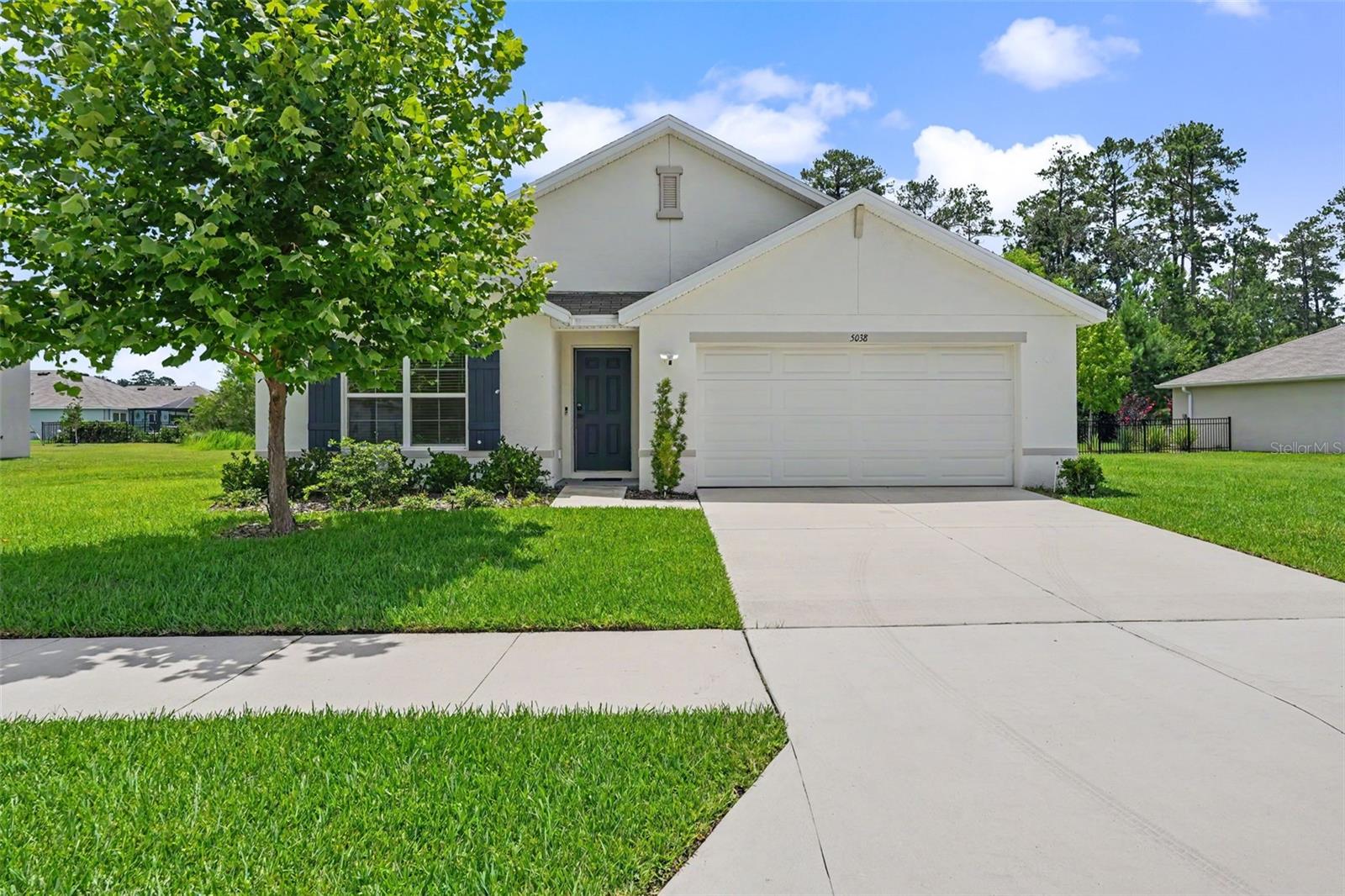 Virtually Staged. Welcome to 5038 Cadiz Ct. in Hernando Oaks! This beautifully maintained 4-bedroom, 2-bath home, built in 2022, offers modern living in one of Brooksville's sought-after gated golf course communities. Situated on an oversized quarter-acre homesite, this all-concrete block home combines quality construction with a bright, open floor plan designed for today's lifestyle.
The spacious kitchen overlooks the living and dining areas, making it ideal for entertaining and everyday living. It features abundant cabinetry, generous counter space, and a complete appliance package. The private owner's suite is tucked away at the rear of the home and offers a walk-in closet and an en-suite bath. Three additional bedrooms provide flexibility for family, guests, or a home office.
Step outside to the covered lanai with conservation/green belt behind the property. Enjoy peaceful Florida living with plenty of room to create your dream outdoor oasis, including space for a future pool.
Located within the gated Hernando Oaks community, residents enjoy tree-lined streets, a championship golf course, and convenient access to the Suncoast Parkway, making Tampa an easy commute. Shopping, dining, medical facilities, parks, and the Nature Coast are all just minutes away.
If you're looking for a newer home with modern finishes, an open layout, and a fantastic location, this is one you won't want to miss. Schedule your private showing today!  Some photos are virtually staged.