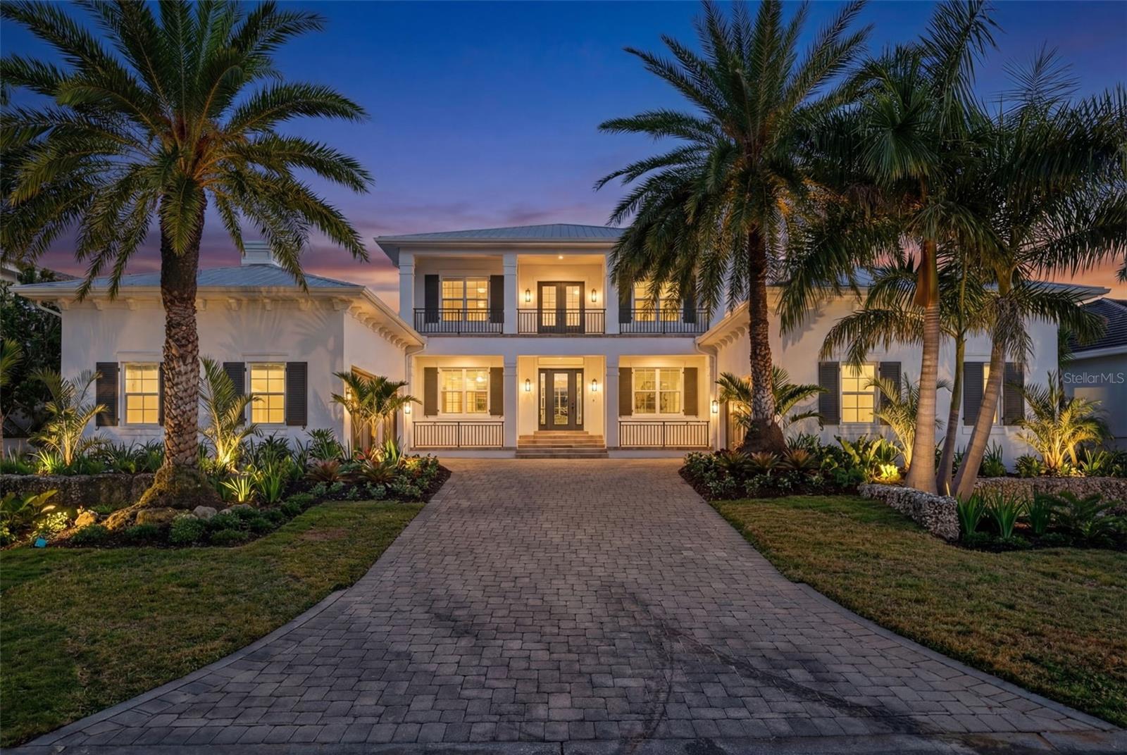 Located in Harbor Acres, one of Sarasota’s most coveted neighborhoods, this coastal traditional residence enjoys an exceptional in-town setting just minutes from downtown and Southside Village, home to 14+ restaurants, Morton’s Gourmet Market, and Sarasota Memorial Hospital—truly the epicenter of city living. Poised on an elevated lot, this newly renovated 4-bedroom, 4-bath home offers a highly desirable and functional floor plan filled with natural light, high ceilings, and abundant windows throughout the main level. The thoughtfully designed first floor features a spacious primary suite with dual closets and a bath with soaking tub, along with an additional bedroom suite and a private office conveniently located near the living room and primary bedroom. The living room is anchored by a fireplace flanked with custom built-in bookcases and opens via sliding glass doors to the covered patio, creating seamless indoor-outdoor flow. A well-proportioned dining room sits just off the kitchen, ideal for both everyday living and entertaining. The open kitchen features new luxury appliances, quartzite countertops, a farmhouse-style sink, beverage refrigerator, custom pantry, breakfast bar overlooking the living room, and a sun-filled breakfast room. An oversized laundry room offers ample space for custom built-ins and includes a new washer and dryer. A full bath on the main level serves both the additional downstairs suite and functions as a pool bath. Recent updates include wide-plank oak flooring, quartzite kitchen countertops, new appliances, new light fixtures throughout, two new air conditioning systems, fresh interior and exterior paint, new vanities in the primary bath and one upstairs suite, and new tropical landscaping that creates a lush garden setting. Upstairs, a large family or game room is flanked by two bedroom suites and opens to a front terrace. Designed for indoor-outdoor living, the home features a screened pool, outdoor dining area, and summer kitchen. A 4-car garage with additional storage completes this exceptional offering. Harbor Acres is renowned for its voluntary homeowners association and strong sense of community, making it one of Sarasota’s most desirable neighborhoods.