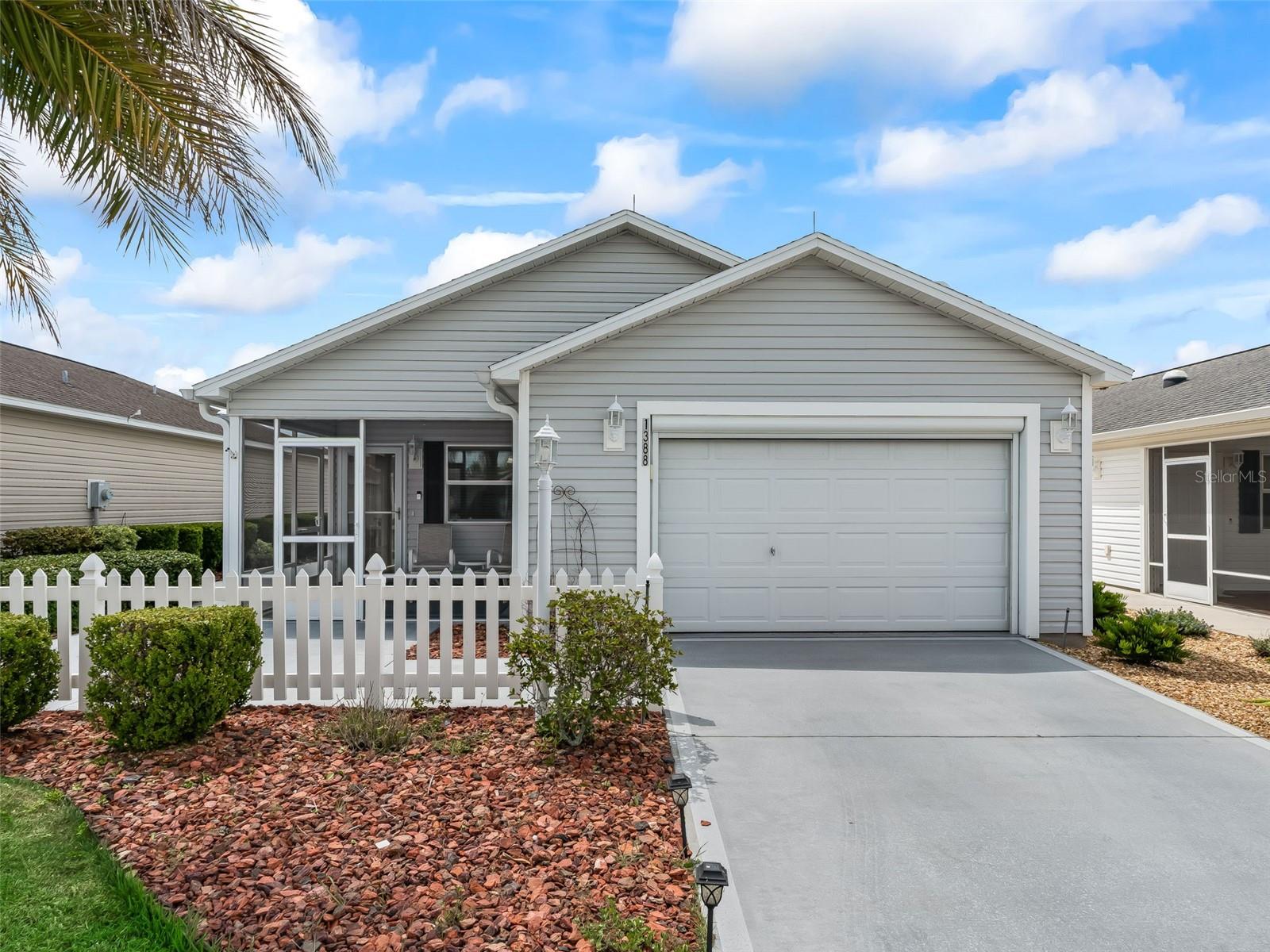 Leyton Villas!  Charming TURNKEY 2/2 Colony Patio Villa with a 1 and a 1/2 Car Garage in the sought after Village of Dunedin! Quiet Tech EFI Gas Yamaha Golf Cart Included!  Whole House Water Softener System! Perfectly situated between Lake Sumter Landing and Brownwood Paddock Town Square where you can Enjoy Live Entertainment 365 Days a Year!  This Colony Patio Villa offers an Open Concept Floor Plan, Fantastic Curb Appeal featuring an inviting White Picket fence, Low Maintenance Professional Landscaping, Painted Concrete Driveway, and an 11 x 10 Front Screened Lanai with both a Painted concrete Front Patio and Nice Size Side Patio!  Just Perfect for Enjoying Outdoor BBQ's, Sunset Dinners, and the Beautiful Florida Weather! As you enter through the Front Lanai you are greeted by the Dining and Living area combination flooded with Natural light, Vaulted Ceilings, and providing an Exceptional Space for Entertaining Friends and Family!  The well designed floor plan offers convenient sliding door access from the Living and Dining area to the side patio, Great for BBQ's!  The Screened Lanai, creates a Fantastic additional living space, perfect for dining, enjoying Beautiful Florida Sunsets, and Tropical Breeze!  The Kitchen showcases a nice size Breakfast Bar, Pantry closet, Stainless appliances, Plenty Counter space & Solid Wood Cabinetry, Eat in Area, and opens to the living, and dining area!  The 16 x 12 Primary Suite offers a Large Walk in Closet, and an En Suite bathroom, with the En Suite featuring a Walk in Shower, and Corian Topped Vanity.  Guest bedroom 2 provides a nice size built in closet, and convenient access to the guest bathroom highlighting a Tub and Shower Combination, and a Corian Topped Vanity.  Overall this home offers a Fantastic Price, Desirable Location, Great Outdoor Space, and a Well Designed Floor Plan making this home A Must See!  The Village of Dunedin is close to Dunedin Adult Pool & Recreation Center, Manatee Pool & Recreation Center, Manatee Bocce Ball Courts, Eisenhower Regional Pool & Recreation Center, Belle Glade, Bonifay, and Evans Prairie Championship Golf Courses and Country Clubs, Colony Cottage and Rohan Regional Recreation Centers, Sarasota Golf Practice Center, Sharon Rose Wiechens Preserve, Atlas Dog Park, Colony Plaza, Plenty of Shopping, Restaurants, Medical Offices, and More!