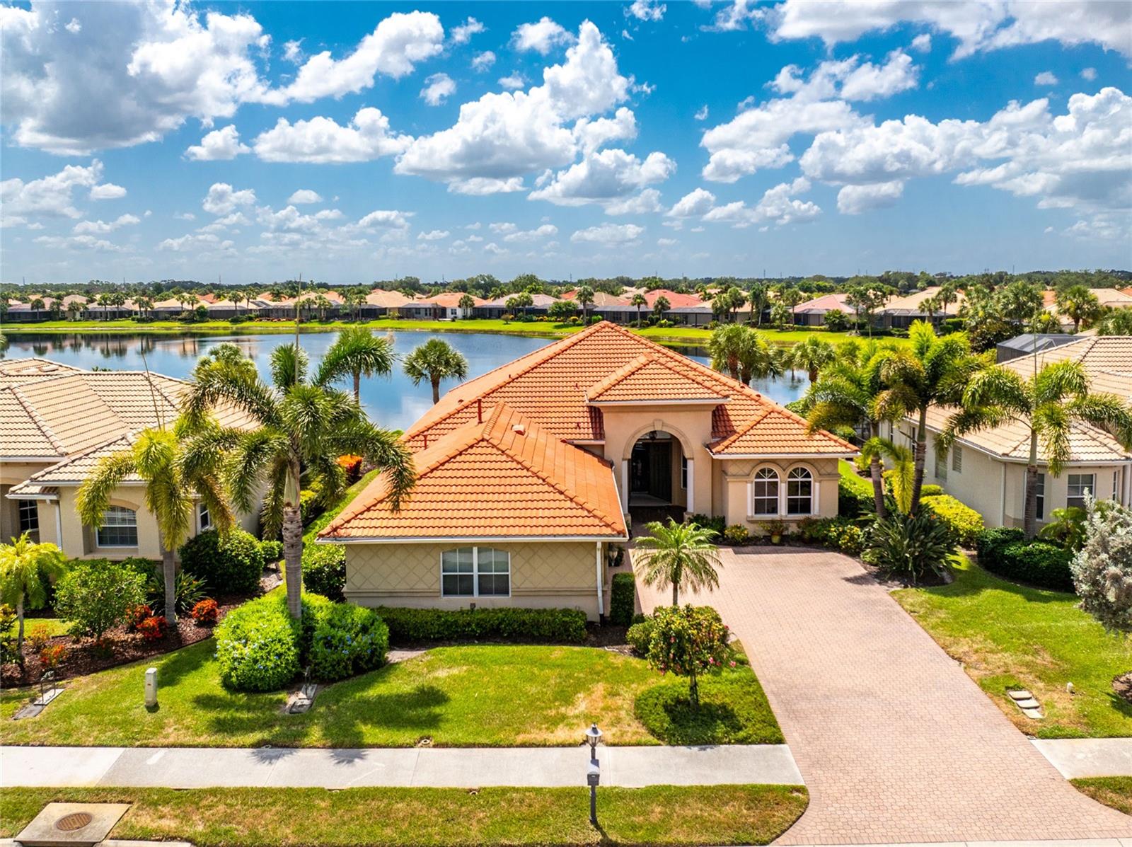 Enjoy the STUNNING RELAXING WATER VIEWS From Your EXTENDED SCREENED PAVER LANAI in this WCI Built Da Forli Model Featuring 3 BEDROOMS, 3 BATHS plus a 3 CAR Side Load GARAGE ALL SITUATED IN THE GATED  community of  the VENETIAN GOLF AND RIVER CLUB.  This home is great for ENTERTAINING with its welcoming foyer to the SPACIOUS OPEN FLOOR PLAN. A newly renovated kitchen that will please the cook with its airy appeal, quartz counters with updated pendant lighting, wood cabinetry, built in oven, a gas cook top, a cafe style dining area open to the FAMILY ROOM and GREAT ROOM. The great room and the formal dining room both have custom tray ceilings. Working from home  is a breeze as you have an office here featuring beautiful wood flooring; this room could be a fourth bedroom. Owner's suite with water views, tray ceilings, his and her walk- in closets, bath with dual sinks, a garden tub and separate shower. For peace of mind, all windows are hurricane impact and sliders are protected with an electric hurricane shutter.  Three sets of sliders leading to the SPACIOUS SCREENED lanai with soothing water views . Beautiful tile flooring in the common areas. Paver drive and lovely landscaping. This home is a must see! The Venetian Golf and River Club offers a championship 18-hole golf course where membership is optional, large, heated community pool and lap pool, six Har-Tru tennis courts, a first-class fitness center with an exercise room, and a 70-acre nature park nestled along the Myakka River. There is a poolside Tiki bar and fine dining at the River Club restaurant. All of this and only a short drive to the best Gulf Coast beaches and attractions of downtown Venice. Every day conveniences include nearby shopping, easy access to I-75, restaurants, cultural events, the legacy bike trail, Sarasota Memorial Hospital on Laurel Road and so much more!