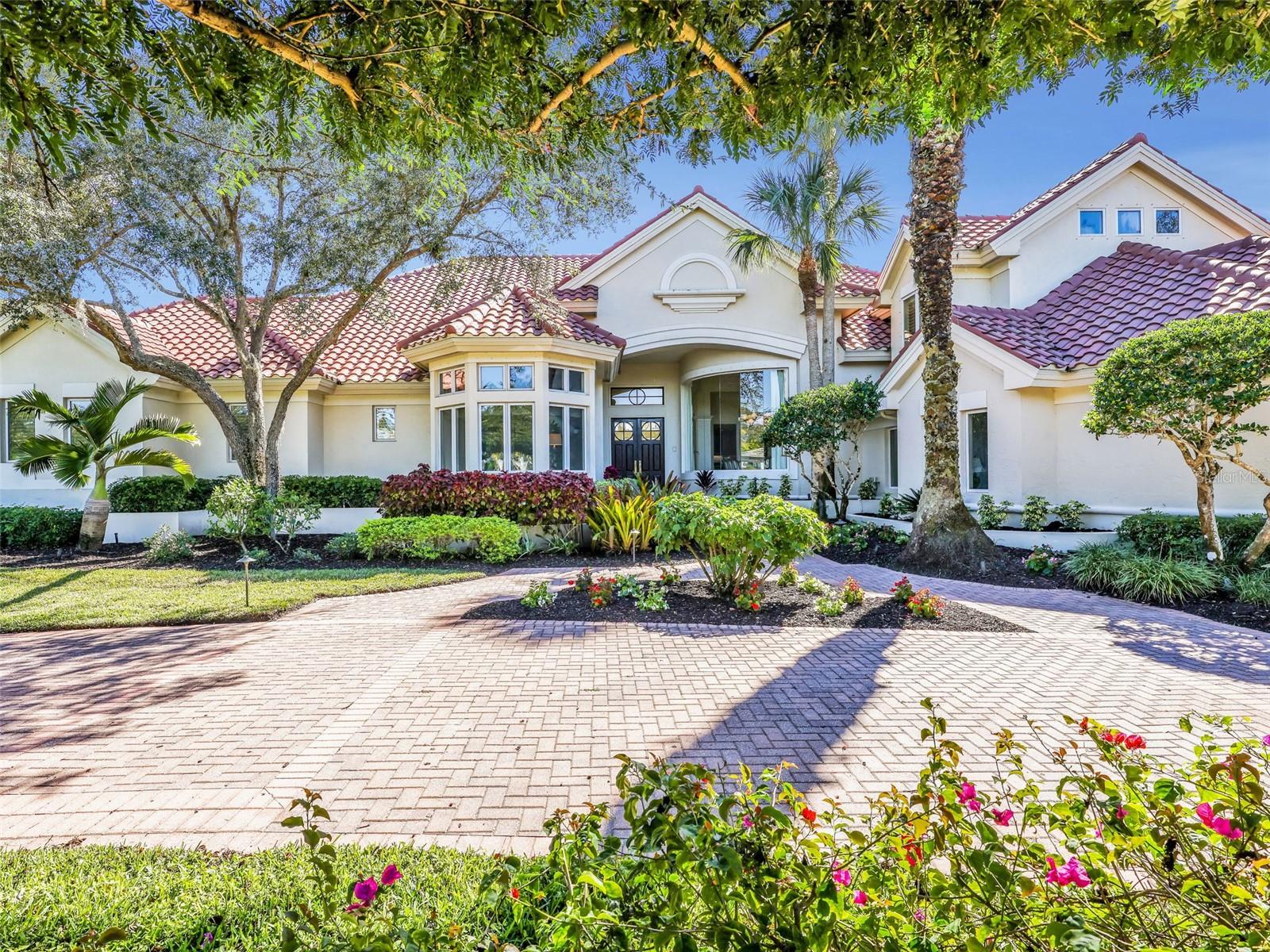 Virtually Staged. Skip the Waitlist for a Transferable Equity Golf Membership available IMMEDIATELY at closing. Nestled on an oversized 0.75-acre lakefront lot in the exclusive Quail West, this 6,046 sq. ft., 4bedroom, 7 Bath, 3 car garage residence stands as the Largest Value-Added Estate currently for sale in Quail West: Historic Scale meets Modern Potential. While the home serves as a magnificent canvas for your personal vision, the high-ticket mechanical updates are already complete, including a NEW Tile Roof (2022), NEW HVAC systems and Smart Thermostats (2025), NEW Water Heaters and other plumbing (2025), and Fresh exterior Paint (2023). The open concept floor plan features a grand foyer with soaring vaulted ceilings, a dedicated den/office, a second-floor media suite, a chefs kitchen with adjoining family room, spacious Primary Wing with dual spa-inspired bathrooms with connecting second laundry room, private workout room and direct entry to the pool. Offering total autonomy, the private-entry detached guest house is perfect for multi-generational living, long-term guests or home office. Step outside to a golfer’s dream, where an expansive open lanai with a heated gas pool/spa and summer kitchen offers southern-exposure views of the lakes and championship course with breathtaking sunrises and sunsets. Located just steps from the premier resort-style clubhouse and the first tee of 2 championship courses, this estate is the ultimate strategic acquisition for the buyer seeking instant equity and immediate access to this unrivaled lifestyle in Naples.