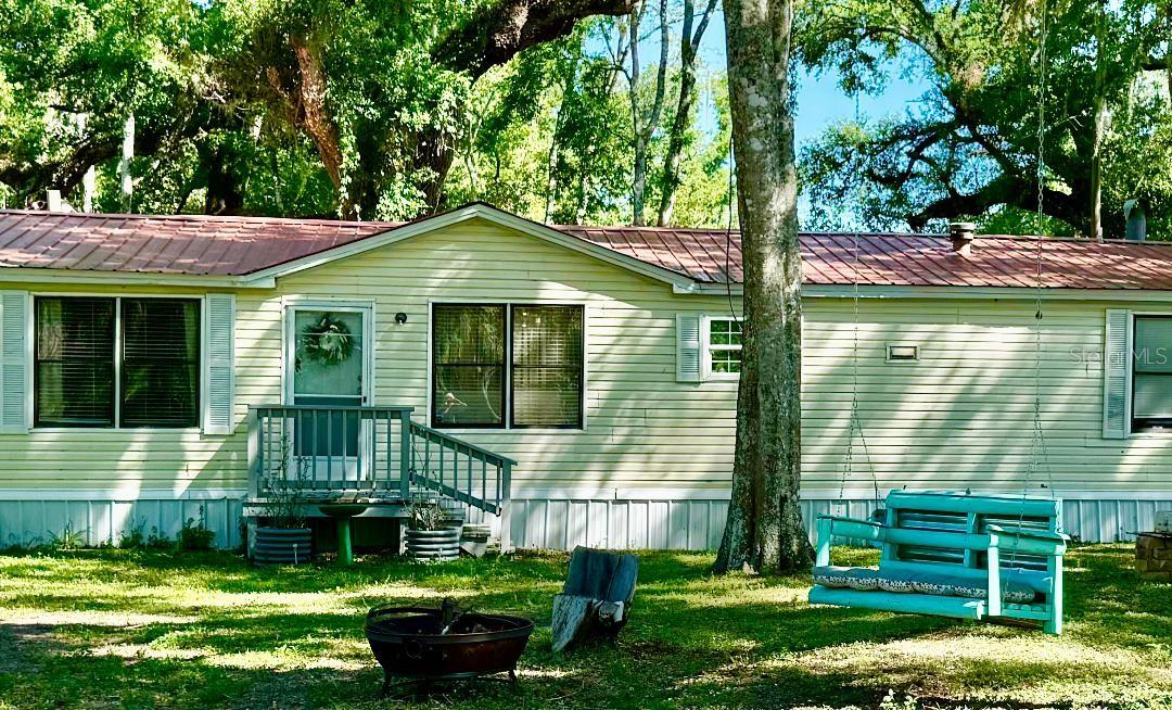 1.9 acres 3/2 nicely kept large home, great for chickens, in Webster, just over the Sumter County Line. This big, beautiful home has 3 bedrooms and 2 baths, with large kitchen with storage, dining area, living room, family room with fireplace, with a large, covered entry area that is great for meeting. There is plenty of room for parties outside and inside. There is a washer & dryer hookup. The area is just beautiful with much shade and large trees, and plenty of parking. There are many chickens, with more areas for more small animals, and a pond like run-off, where ducks are now. Owner is motivated and this is a Cash Sale only. Thank you for viewing