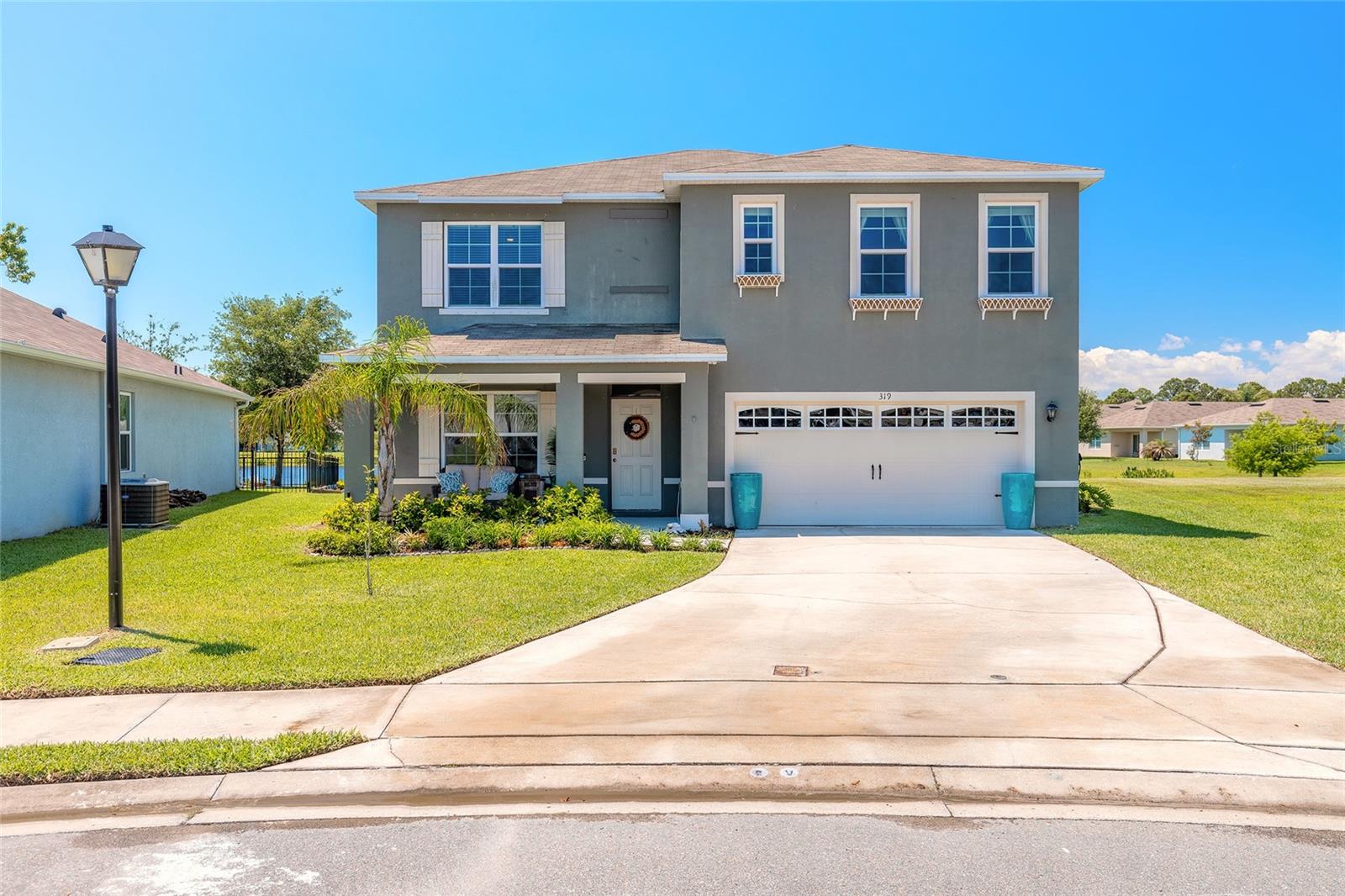 Welcome to this beautifully maintained newer construction home located in the desirable Woodbridge Lakes community Of Edgewater! This spacious 5 bedroom, 3 bathroom, two-story home offers over 2762 ft.² of living space with an open concept floor plan perfect for entertaining and everyday living. Built in 2021, featuring a large kitchen overlooking the living and dining areas, beautiful chandelier in kitchen and dining, ample cabinetry with beautiful granite countertops, all the spacious bedrooms, flex areas and a flexible layout, ideal for multi-generational living, working from home, or growing family. This oversize primary suite offers a private retreat and generous closet space with built in shoe racks & storage, an en-suite bathroom with all necessary accessories. So many upgraded features including finest stylish board & batten wall design in one of the other bedrooms.  Enjoy the peaceful pond stocked for resident fishing from your backyard with room to relax and entertain on the largest lot in this community.  Fresh sod, upgraded irrigation system including many zones, cafe lighting around oversized deck and concrete umbrella stands for stability all surrounding the large 16 x 40 beautiful stained wood deck and best of all this home sits on the largest lot in the community,  situated on approximately .18 acres with a two car garage featuring fresh epoxy flooring.   The list of upgrades for this home seem endless with new luxury vinyl plank flooring throughout, upgraded 5" baseboard install July 2025, three bedrooms with fresh carpet, specialty tile, backsplash, coordinated with granite in the kitchen, pendant lighting in all three bathrooms, ceiling fans with dimmers and motion activated sensors installed in five areas, corner nook for TV with a built-in telescoping TV mount and LED fireplace with hidden storage and a mantle in the family room, privacy landscape with Areca Palms, sea grapes, bottle palms, plum trees, and apple trees in front.  A customize laundry room for organization and storage, pre-HOA approval for a pergola over the garage and stone walkway left of driveway for future installation if interested. Window treatment blinds.  (curtains do not convey) This yard has been treated twice a year for fire ants and bugs.  Also includes built in shoe racks and storage under stairs… The list just goes on and on!!  This home is conveniently located near shopping, dining, parks, schools, the intercoastal waterway, and just a short drive to the beaches of New Smyrna Beach. This home also features as a smart home and options for fiber optics. Easy access to I-95 makes commuting a breeze. Low HOA and plenty of space to make this home a must see!!!  Truly dynamic!!