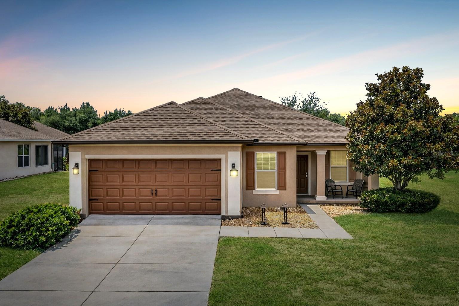 Resort-style living awaits in this spacious Shenandoah model, ideally positioned on a coveted oversized lot in the Arlington neighborhood of the gated 55+ Stone Creek Golf Course Community. Offering 2 bedrooms, 2 baths, a versatile flex room, and an extended 2-car garage perfect for hobbies or golf cart storage, this home delivers comfort, convenience, and thoughtful design throughout. A welcoming front porch and foyer lead into a bright, airy gathering room where luxury vinyl plank flooring, elegant crown molding, and a full wall of glass sliders set the tone for relaxed, effortless living. The bonus flex room offers a comfortable spot for a home office or den, while the enclosed Florida room with an insulated ceiling extends your living space with a sunlit setting perfect for gatherings or simply unwinding. The Chef’s kitchen overlooks the gathering room and features stainless steel appliances, granite countertops, a generous pantry, and abundant 42” cherry cabinetry. A casual dining nook with sliders to the Florida room adds even more flexible space for entertaining or enjoying relaxed meals with friends. The owner’s suite offers a peaceful retreat with a spacious walk-in closet and French doors opening to a well-appointed en suite bath, complete with a double-sink vanity and dressing table, step-in shower, spa-like soaking tub, and a private water closet. 
The guest bedroom offers a comfortable retreat for visitors or a quiet spot for hobbies, while the thoughtfully designed laundry room adds everyday ease with its convenient laundry tub and dedicated folding table. Outside, the spacious backyard becomes a true extension of your living space, offering plenty of room for gardening, outdoor seating, or weekend barbecues. A fenced-in area provides a safe, open space for your furry friends to play, making the backyard both functional and welcoming for everyday enjoyment. Recent upgrades include a new water heater (7/25), new roof (12/24), and an updated AC system (5/26) for added peace of mind. Fresh attic insulation and ceiling fans in every room add comfort and energy efficiency throughout the home. And with a proposed community swimming pool just a short walk away, you’ll enjoy even more convenience and recreation close to home. Make your move today and embrace the exceptional lifestyle of this vibrant community, featuring a 24/7 staffed gated entrance for security and peace of mind. Luxury-inspired amenities include heated pools, a state-of-the-art fitness center, a spa, and relaxing hot tubs and saunas. Stay active with pickleball, bocce, tennis, and a softball field, while a dedicated lifestyle staff curates entertainment, activities, and special events to foster connections. This master-planned community also offers a golf course, pro shop, and inviting on-site restaurant, creating effortless opportunities to relax, connect, and enjoy the Florida lifestyle.