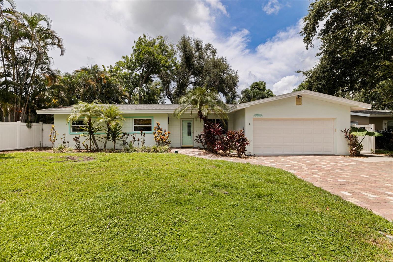 POOL HOME IN A NON-FLOOD & NON-EVACUATION ZONE JUST 2 MILES FROM THE BEACH! Thoughtfully updated with a tropical backyard, saltwater pool, and air-conditioned garage.

Located in the Harbor Crest neighborhood, this 3-bedroom, 2-bath concrete block home offers 1,440 heated square feet, a saltwater pool, an air-conditioned two-car garage, and a fully fenced backyard in a non-flood zone with no evacuation requirement. Just two miles from the Gulf beaches and minutes from Largo Golf Course, Walsingham Park, and the 90-acre Florida Botanical Gardens, this property combines peace of mind with an exceptional Florida lifestyle.

The open living and dining room flows seamlessly into the kitchen and spacious sunroom, creating comfortable everyday living and an ideal layout. Porcelain tile flooring extends throughout the home for durability and easy maintenance.

The kitchen features granite countertops, solid wood cabinetry, a pantry cabinet, and a new refrigerator installed in 2025. Convenient pass-through windows connect the kitchen to the covered lanai, making outdoor dining and poolside gatherings effortless.

Step outside into your own private tropical retreat. Installed in 2017, the screened saltwater pool is enclosed beneath a birdcage for lower maintenance and surrounded by mature royal palms and lush tropical landscaping. Travertine pavers extend across the covered lanai, which is plumbed with hot and cold water. An outdoor shower, fire pit area, bird bath, bird feeder, dog run, doggy door, irrigation system supplied by reclaimed water, and a six-foot vinyl privacy fence complete this peaceful backyard oasis.

One of the home's most versatile features is the insulated, air-conditioned two-car garage, offering a comfortable environment for projects, hobbies, fitness equipment, or additional storage year-round. An oversized paver driveway provides parking for up to six vehicles.

Buyers will appreciate the extensive list of major improvements, double-pane insulated windows (2012), roof (2014), HVAC (2014), all new ductwork (2021), whole-house water filtration system (2014), upgraded 200-amp electrical service with generator-ready capability, inside laundry, and reclaimed water irrigation.

Whether you're looking for a primary residence, seasonal home, or Florida retreat close to the Gulf beaches, 13555 Croft Drive delivers the features buyers value most: concrete block construction, a non-flood location, private pool, major system updates, generous parking, and outstanding access to parks, golf, and some of Pinellas County's most beautiful beaches.