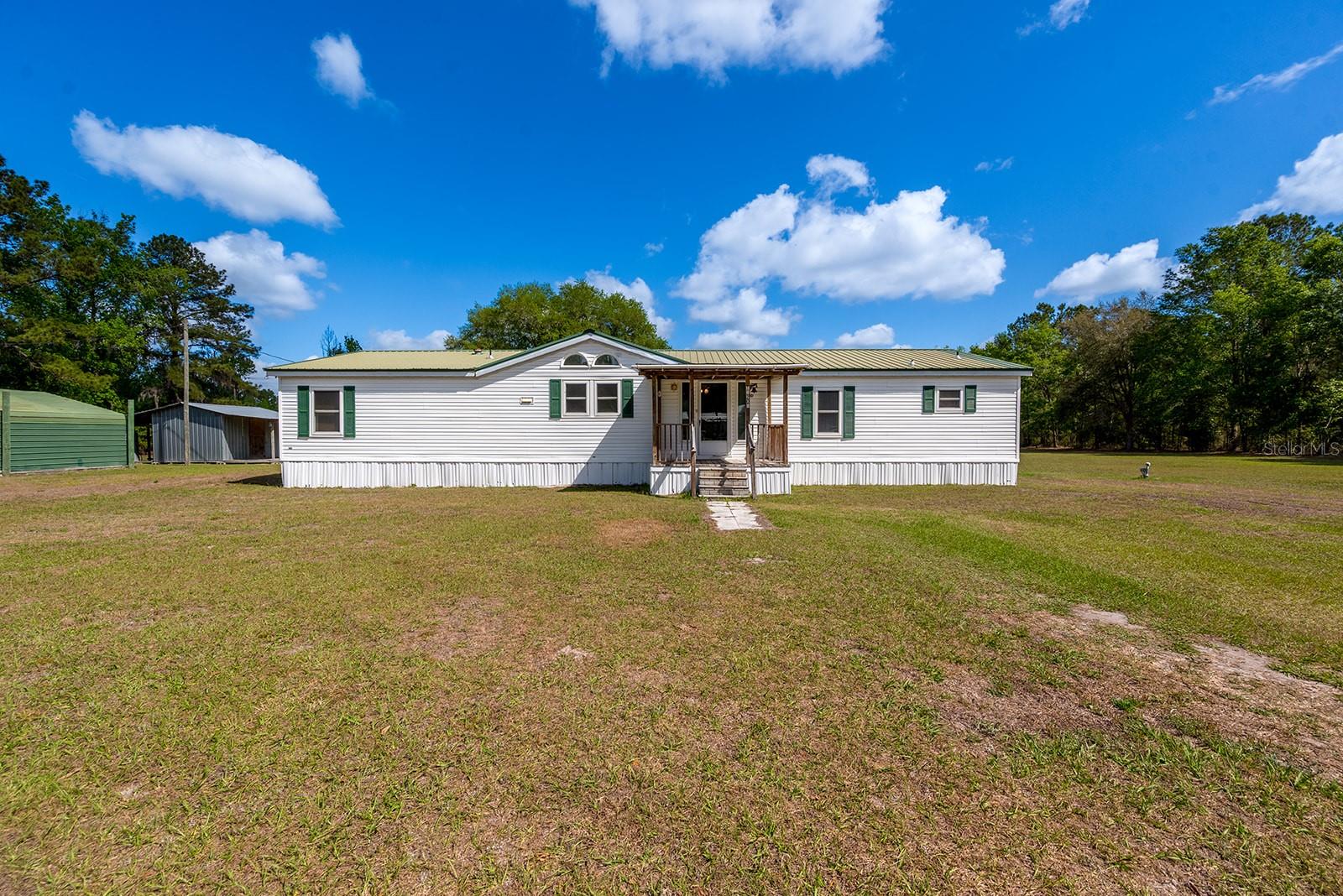 Escape to the peace and privacy of country living with this 3-bedroom, 2-bath home situated on 3 fully fenced acres in Union County. This property offers the perfect blend of space, functionality, and freedom—ideal for those looking to bring animals, run a business from home, or enjoy wide-open living. The home features a comfortable layout with plenty of natural light, creating a warm and inviting atmosphere for everyday living. Step outside and take in the expansive acreage, already fenced and ready for livestock, pets, or recreational use.
A standout feature of this property is the three on-site shops, offering endless possibilities for storage, hobbies, workshops, or small business use. Whether you need space for equipment, projects, or additional workspace, this property delivers.
Whether you're looking for a quiet retreat or a place to grow, this property gives you the flexibility to make it your own while still being conveniently located to nearby towns and amenities. Don’t miss your chance to own a slice of North Florida land with room to live, work, and play.