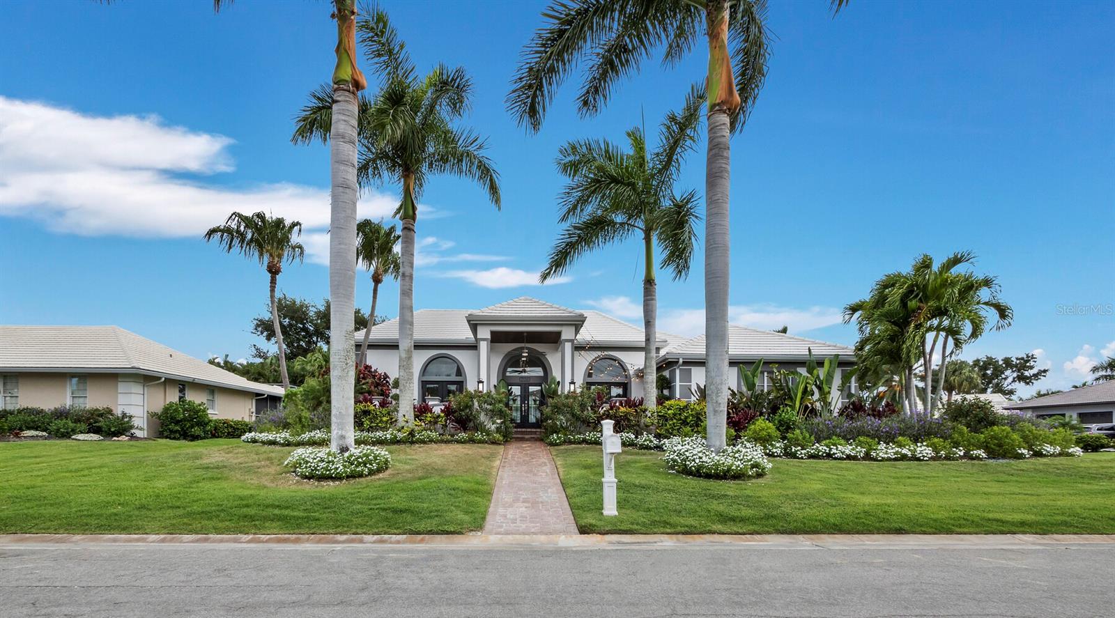 Offering 3 bedrooms, 2 baths, den/office, 2,411 square feet under air, a spacious living room, a 2-car garage, and a private 14' x 37' heated pool centrally positioned as the focal point of the home. This beautifully updated, move-in-ready residence blends luxury, comfort, and the ultimate coastal lifestyle in the highly sought-after waterfront Southbay Yacht & Racquet Club - Marina Community.

The thoughtfully designed split floor plan is ideal for indoor-outdoor living. Multiple rooms overlook and open directly onto the covered lanais and the private heated pool, which is framed on three sides by the home creating a stunning courtyard oasis. Dramatic floor-to-ceiling impact-rated windows and sliders (2020) frame beautiful pool views, while soaring ceilings and an abundance of natural light enhance the bright, open feel.

The luxurious primary suite includes an adjoining office/den and an ensuite bath with soaking tub and custom cabinetry. Two guest bedrooms and an updated guest bath are located in a separate wing. A custom queen-size library-style Murphy bed adds flexibility for guests or workspace.

Step inside to discover stunning 12” x 72” Ceramica Sant’Agostino Italian porcelain plank tile flooring (Barkwood Ash) throughout, soaring ceilings, custom millwork, new 8-inch baseboards, upgraded lighting and fans, and fresh interior and exterior paint (2025). The chef-inspired kitchen features all-new custom cabinetry, quartz countertops, a large center island with seating for 8-10, high-end 2025 GE Monogram appliances (including 48” refrigerator, induction cooktop, and wall oven/microwave), a built-in wine refrigerator, and excellent storage. The open dining area includes a beautifully integrated bar with custom cabinetry and a fireplace (ready for insert).

Additional highlights include dual-zone A/C systems (new 2025), new Electrolux stackable washer and dryer (2025), spacious laundry room with utility sink and coffee/tea bar, new concrete tile roof (2020), re-plumbed (2007), oversized 2-car garage with epoxy floor and custom storage, mature tropical landscaping with irrigation, private outdoor shower, and room to add a 4th-bedroom with ensuite bath or additional garage storage.

Located in the desirable Southbay Yacht & Racquet Club - Marina Community, this premier boating community features a private 172-slip deep-water marina that can handle vessels up to 58 feet for very reasonable fees. Residents enjoy low HOA fees and a wonderful social atmosphere with a clubhouse, fitness center, heated community pool, spa, tennis courts, pickleball, basketball, bocce, playground, kayak launch/storage, jet ski pads, and more. This golf cart-family friendly community offers easy access to Nokomis Beach, Casey Key, waterfront dining, shopping, Publix, Aldi, restaurants, and tiki bars.

All interior and exterior furnishings, artwork, TVs, potted plants, and outdoor gas grill with pizza oven are available for purchase separately via bill of sale.

This is a must-see, comprehensively updated home in Southbay.