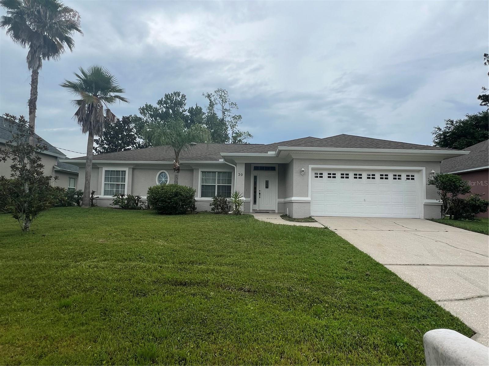 Move-in-ready, 3 bedr./2-bath./2-car garage rental home perfectly situated on an elevated lot in the highly desirable Pine Lakes subdivision. Offering 1,791 sq. ft. of comfortable living space (2,583 sq.ft. total), this residence perfectly blends privacy, comfort,& functional design. Brand-new, sleek Vinyl Laminated Flooring has just been installed in all bedrooms, paired with easy-to-clean tile throughout the main living areas and wet spaces, and the home is equipped with a brand-new refrigerator, matching appliances, and a cozy dining nook. A large window and glass door in the breakfast nook flood the space with beautiful, comforting natural light while overlooking a peaceful, lush green backyard. A beautifully accented fireplace elegantly divides the kitchen from the main family room, creating a warm and welcoming focal point for the home. Designed for maximum privacy, the layout ensures space for everyone: tucked away privately at the end of an arched hallway, featuring a light & spacious Master Bedroom with an expansive walk-in closet and a private en-suite bathroom with two vanities, & a separate walk-in shower. Located on the opposite side of the home, there are two versatile, spacious bedrooms.  One bedroom could be used as a guest room & has excellent closet space (including a walk-in closet with its own window).  Features a bright skylight that brings in refreshing natural light in the guest bathroom. Relax or entertain on the covered back porch, the perfect spot for enjoying the quiet, peaceful surroundings of Palm Coast. Proof of income is required.