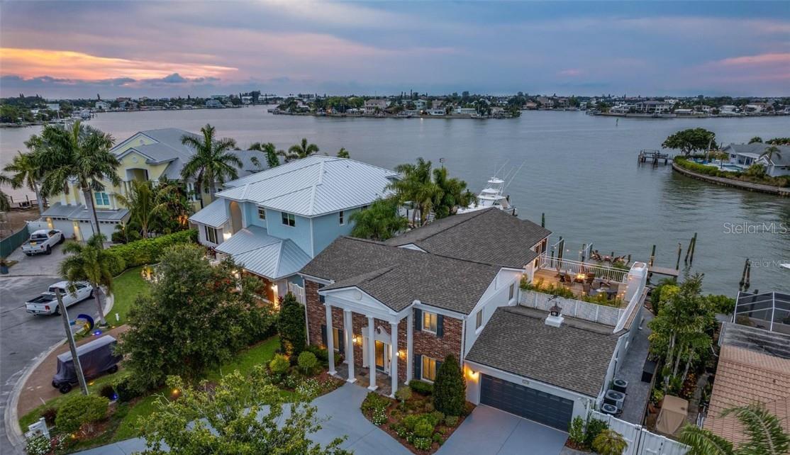 Perfectly positioned within the exclusive waterfront enclave of Harbor Hills, this extraordinary luxury residence is the definition of turnkey coastal sophistication. Showcasing over 3,900 square feet of impeccably redesigned living space, this architectural showpiece has undergone a complete high-end transformation with more than $200,000 invested in premium finishes, designer furnishings, and bespoke upgrades throughout. 
Offering 8 spacious bedrooms, 4 luxurious bathrooms, and a 2-car garage, this fully furnished estate is perfectly tailored for elevated personal living, executive retreats, or a high-performing luxury vacation rental investment. Every inch of the home has been thoughtfully curated with all-new fittings, modern designer finishes, custom details, and refined craftsmanship that create an atmosphere of effortless elegance. 
From the moment you arrive the grand circular driveway, lush tropical landscaping, and commanding waterfront presence set the tone for what awaits inside. Expansive open-concept living areas are flooded with natural light and seamlessly blend indoor and outdoor living, all framed by breathtaking panoramic open water views. 
The outdoor setting is equally spectacular — offering the rare combination of wide-open water vistas with the protection of a sheltered dock, creating an ideal environment for boating enthusiasts and waterfront entertaining alike. Enjoy tranquil sunrises, glowing sunsets, and the ultimate Florida lifestyle from your private waterfront oasis. 
Designed for both luxury and profitability, the property is completely move-in ready and rental ready, operating as a proven turnkey Airbnb investment with exceptional income potential from day one. Whether utilized as an elite waterfront residence, a seasonal escape, or a premier short-term rental asset, this home delivers unmatched versatility and immediate cash-flow opportunity. 
A rare offering where luxury, lifestyle, and investment performance converge seamlessly on the water.