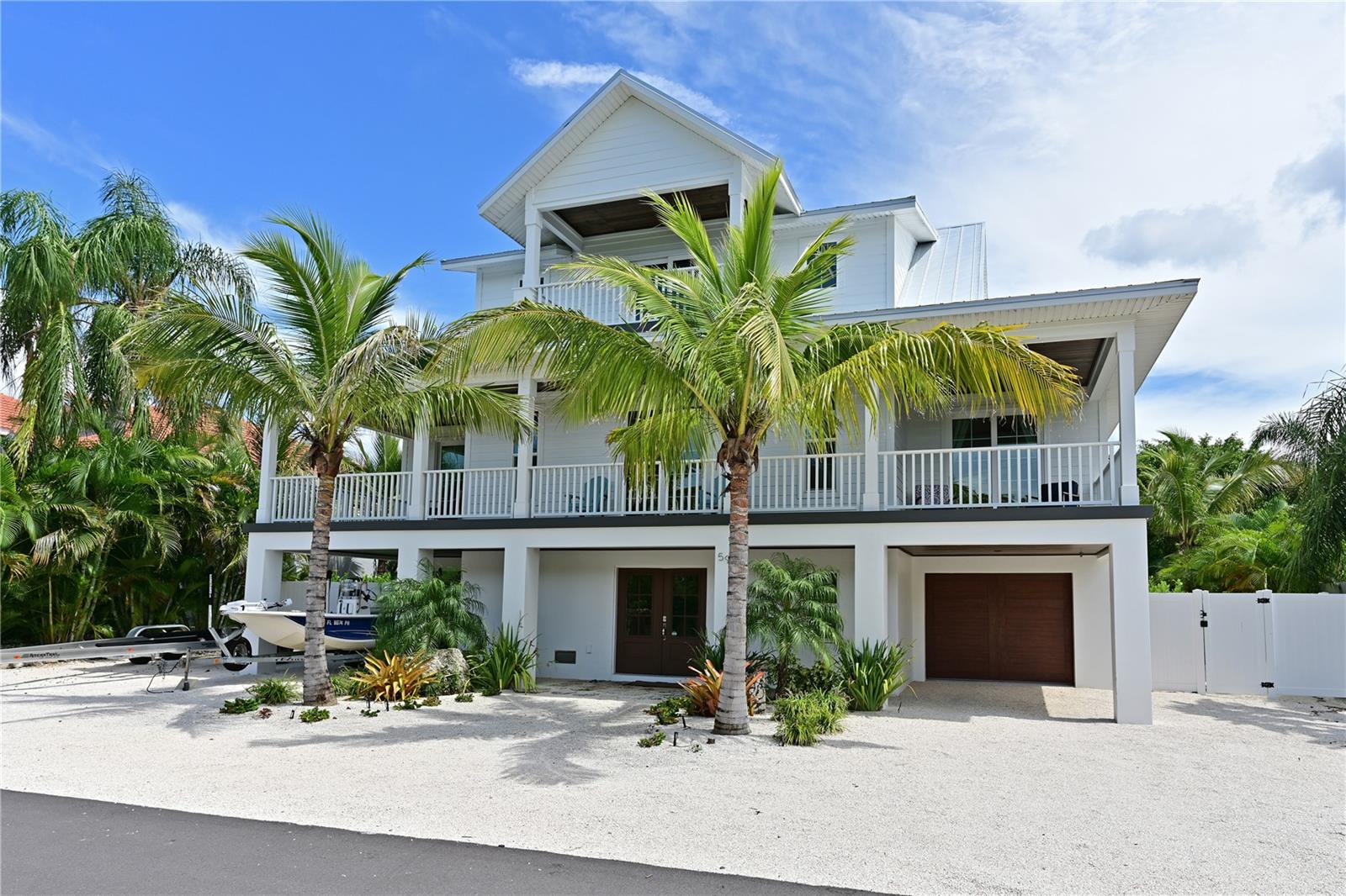 Why renovate or build when you can own this  stunning custom estate home built in 2021. Nestled on one of the canal lots on the exclusive near north end of Longboat Key. Built by Mason Martin builders, this project is the perfect combination of comfort and craftmanship . This  private oasis is built for relaxation and enjoying the Longboat Key lifestyle. Take your bike or paddleboard to nearby restaurants or walk to one of the world-renowned beaches of the Gulf coast. The three story floorplan has  3 ½ bathrooms and 3 spacious on suite bedrooms with an elevator. The master bedroom is located on the third floor for privacy. Check out the pool and spa, the inner deck is covered and extends to the outdoors, providing shaded space for entertaining or watching TV and grilling with the natural gas grill. Outdoor living is highlighted by a 35 ft long lap pool and an expansive terrace for sunbathing and lounging. Pool and spa both have remote controls to heat up or turn on the jets from inside the house. The kitchen has custom cabinet construction, quartz countertops, and offers the highest quality appliances from Wolf and Sub Zero. Kitchen and bathrooms include top of the line fixtures. The master bathroom is complete with a double vanity, walk in shower  and soaking tub. The interior spaces are designed with sliding doors throughout that open up to the decks on each floor . The Design of the residence revolves around the fundamentals of modern gulf coast architecture. The house sits on the canal equipped with a dock and boat lift. Hard to find new construction like this on Longboat Key.  This breathtaking property has everything the island has to offer.