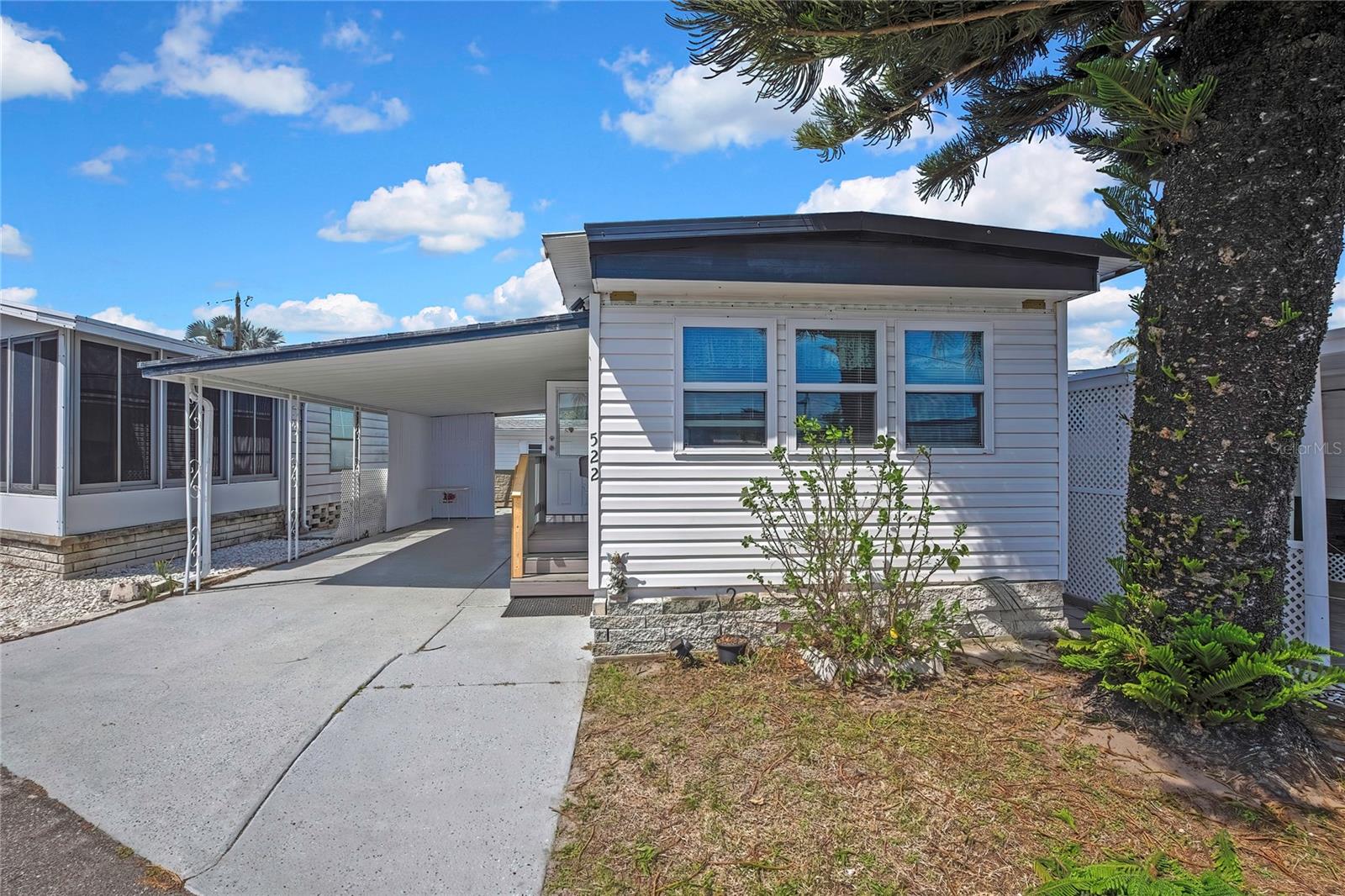 Affordable Florida living in the desirable Wilders 55+ community! This well-maintained 1-bedroom, 1-bath co-op mobile home offers approximately 480 sq ft of comfortable living space and is move-in ready with furnishings negotiable.

The home features an efficient layout with an open kitchen equipped with essential appliances including a range, refrigerator, and microwave. Laminate and tile flooring throughout provide easy maintenance. Recent improvements add tremendous value, including new electrical, updated plumbing, new insulation, and upgraded 2x4 walls with drywall construction—enhancing both durability and energy efficiency. A new gas tank has also been installed for added peace of mind.

Step outside to find a 2-year-old storage shed that includes a washer and dryer, offering convenient in-home laundry and additional storage space. The property also features a spacious carport.

Enjoy exceptional value with no lot rent—a rare find—plus a low monthly maintenance fee of approximately $120, keeping living costs affordable. Located in a friendly and active 55+ community in south St. Petersburg, residents enjoy a welcoming atmosphere with convenient access to shopping, dining, and transportation.

Perfect as a seasonal retreat, primary residence, or low-maintenance Florida getaway—don’t miss this opportunity to own in one of St. Petersburg’s most affordable communities!