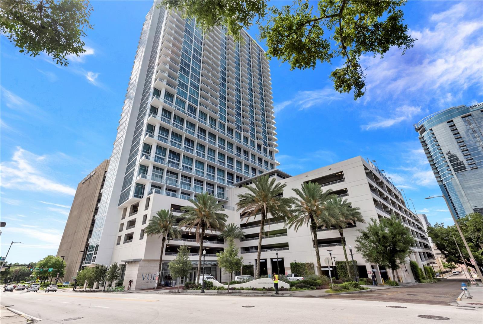 This fully renovated 2 bedroom condo comes with 2 PARKING SPOTS! Features beautiful flooring throughout, great lighting, stainless
steel appliances, backsplash in kitchen, GAS stove, and very tasteful options. This updated unit includes electric blinds throughout on the floor to ceiling windows.  Not only is the kitchen renovated, but BOTH bathrooms are renovated!  The master bedroom includes electronic blinds on the floor to ceiling windows and the ensuite includes two walk in closets, dual sinks, a soaking tub, and a shower.  
The Vue is still the latest condo high rise building built in downtown Orlando. It offers 24/7 concierge and
security, valet parking, and biometric fingerprinting. The building’s state-of-the-art amenities include an impressive fully- equipped fitness center, a yoga studio, a spacious lounge (with theater room), grills, a rooftop heated pool, cabanas, basketball and tennis courts, and a dog run. This is urban luxury high-rise living at its finest!