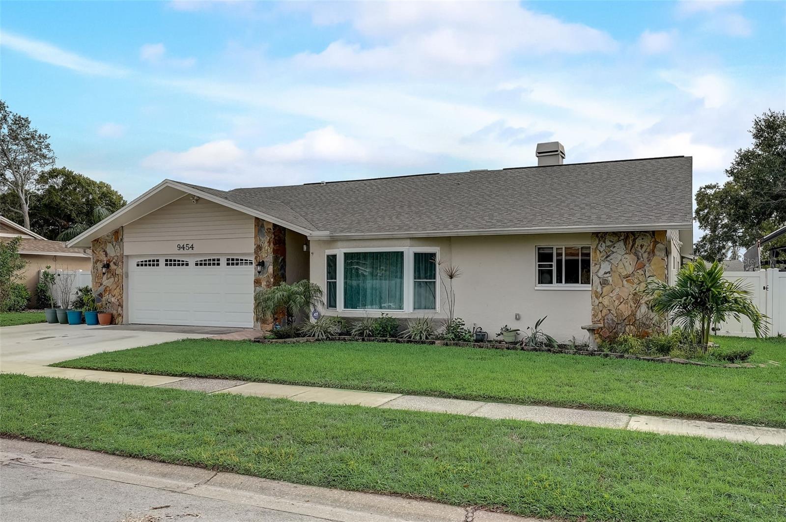Check out the virtual tour! Come home to this one story 3,030 sqft residence with 5 bedrooms & 4 bathrooms PLUS A DEN or HOME OFFICE located 1 mile from Seminole High School! The open concept floor plan connects the dining room and living room with the recently updated kitchen (2021) allowing for easy conversation while cooking and entertaining. Nearby the family room opens to the lanai with new impact rated sliding glass doors (2022). Outside enjoy the spacious lanai surrounding the SALT WATER POOL. Let your dogs roam the fenced back yard and keep an extra vehicle parked in the expanded driveway. The 2 car garage has a recently installed impact rated garage door (2022). Located in Flood Zone "X", so no flood insurance is required, yet this home is a less than 10 minute drive to the beaches! No HOA & located inside UNINCORPORATED Pinellas County. Zoned for Seminole High School, Seminole Middle School and Oakhurst  Elementary School. RECENT UPDATES INCLUDE: shingle roof (2020), A/C ducting resealed (2022), new R38 attic insulation (2021), resurfaced pool (2022), new lanai & pool deck pavers (2022), new gutters (2020), new garage door opener (2020), impact rated sliding glass door in the primary bedroom leading to the lanai (2022), and waterproof vinyl flooring in the main living areas (2020). Well water irrigation system. Ready to be your forever home!