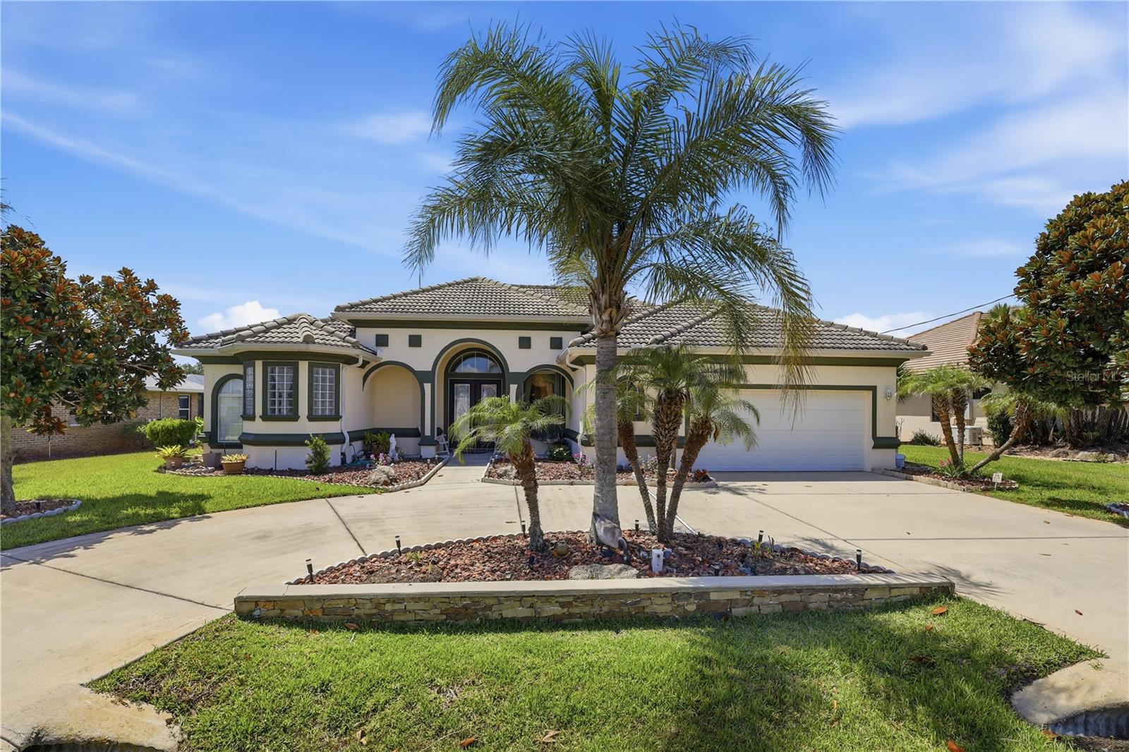 Waterfront Living with Direct Intracoastal Access! Discover the incredible potential of this waterfront home, ideally situated on a beautiful saltwater canal with direct access to the Intracoastal Waterway. Offering 4 bedrooms, 3 full bathrooms, large in ground pool and over 2,500 square feet of living space, this home provides the perfect opportunity to create your dream waterfront retreat. The spacious floor plan is designed for comfortable living and entertaining, featuring hardwood floors throughout the main living areas, multiple gathering spaces, and expansive windows that bring in natural light and showcase peaceful water views. The primary suite is a private retreat with a large walk-in closet and a spacious en-suite bathroom featuring dual vanities and a large walk-in shower. One of the guest bedrooms is designed as a private suite with its own bathroom, making it ideal for guests, multigenerational living, or an in-law suite. Step outside to the screened pool and spacious lanai overlooking the canal, where you'll enjoy beautiful water views and the relaxing Florida lifestyle. The private dock offers direct access to the Intracoastal Waterway, making it easy to spend your days boating, fishing, kayaking, or simply enjoying life on the water. Located in one of Palm Coast's most desirable saltwater canal neighborhoods, this home offers no HOA and no CDD fees. Just 3.5 miles from Flagler Beach and conveniently close to shopping, dining, parks, schools, scenic walking and biking trails, golf courses, medical facilities, and major highways, you'll enjoy both privacy and convenience. While the home could benefit from some updating, it offers an outstanding opportunity to add your personal touches and build equity in a prime waterfront location. Homes with direct Intracoastal access are always in demand—don't miss your chance to own a true Florida waterfront lifestyle.