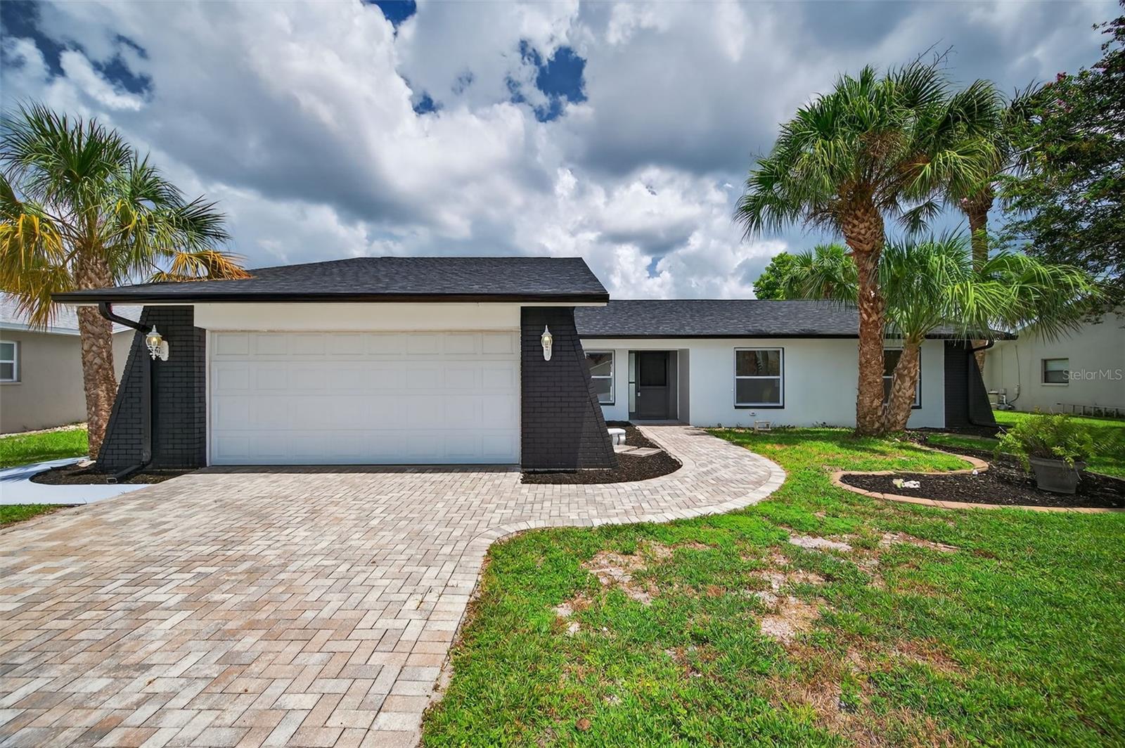 Virtually Staged. Welcome to your own private Florida retreat—where modern updates meet resort-style outdoor living! This beautifully renovated pool home features a new roof (2025), new water heater (2025), updated windows (2025), and a new electrical panel (2025). Enjoy fresh interior and exterior paint, brand-new luxury vinyl plank flooring throughout, and new ceramic tile in the kitchen and entryway. The updated kitchen boasts stylishly fresh cabinetry, granite countertops, a new backsplash, and stainless-steel appliances. Both full bathrooms have been completely remodeled with new vanities and ceramic tile, while modern lighting and a cozy fireplace add warmth and style. Step outside to your backyard oasis featuring a sparkling pool, screened lanai, and spacious patio/deck—perfect for entertaining and enjoying the Florida lifestyle. Conveniently located near local and popular chain restaurants, beautiful Gulf Coast beaches, shopping, and major hospitals. Schedule your showing today!