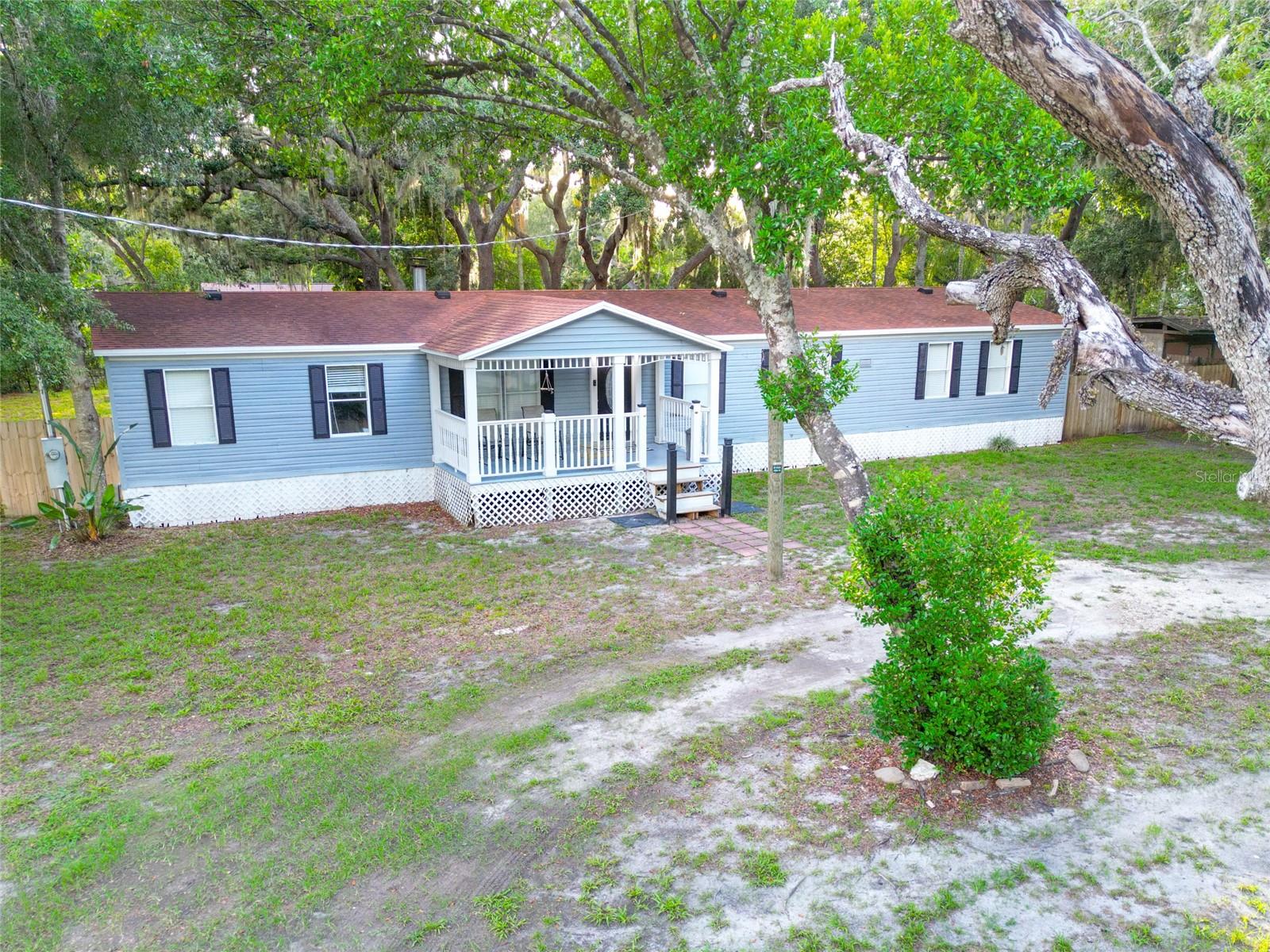 Welcome to this spacious 3-bedroom, 2-bath manufactured home offering over 2,000 square feet of comfortable living space on a peaceful half-acre lot in desirable Odessa. Tucked away just off SR 54, this property offers a private, country-like setting while remaining minutes from the Veterans Expressway, shopping, dining, and the nearby multi-use trail.

Surrounded by mature oak trees, the home welcomes you with a charming country-style front porch and a large rear deck that's perfect for grilling, entertaining, or simply enjoying the tranquil backyard. Inside, you'll find fresh interior paint, an inviting eat-in kitchen, and an expansive family room centered around a beautiful wood-burning fireplace, creating a warm and comfortable gathering space. The generous floor plan provides plenty of room for everyday living, while the half-acre homesite offers space for gardening, outdoor activities, or storing your recreational toys. No HOA or CDD! 

If you're looking for a home that combines privacy, convenience, and over 2,000 square feet of living space in a sought-after Odessa location, this is one you won't want to miss!