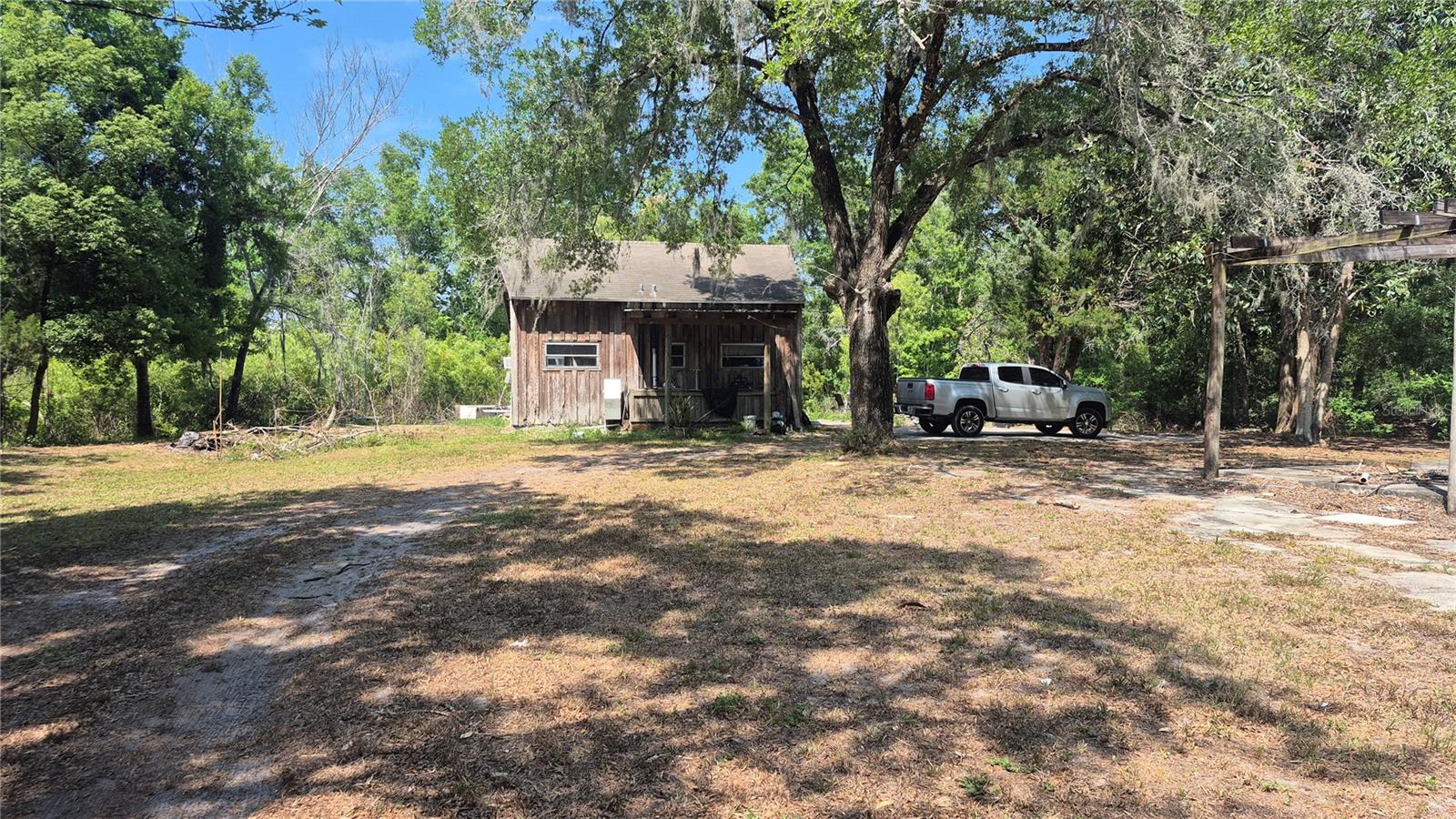Escape to your own private sanctuary on 7.78 heavily wooded acres filled with abundant wildlife and natural beauty. This unique property offers the perfect blend of country living and convenience, located on the corner of Moon Lake Road with easy access to the Veterans Expressway, making commuting a breeze while enjoying peaceful rural surroundings.
The charming cozy cabin overlooks a picturesque pond, creating the ideal setting to relax and enjoy nature. Bring your horses, livestock, and outdoor hobbies—there's plenty of room to roam on this beautiful acreage.
A standout feature is the huge wood-frame metal building, offering endless possibilities for storage, workshop space, business use, equipment housing, or recreational pursuits. The building also includes a private apartment, providing flexible living arrangements for guests, family members, caretakers, or rental potential.
 Additional improvements include a separate storage shed for even more space and functionality.
