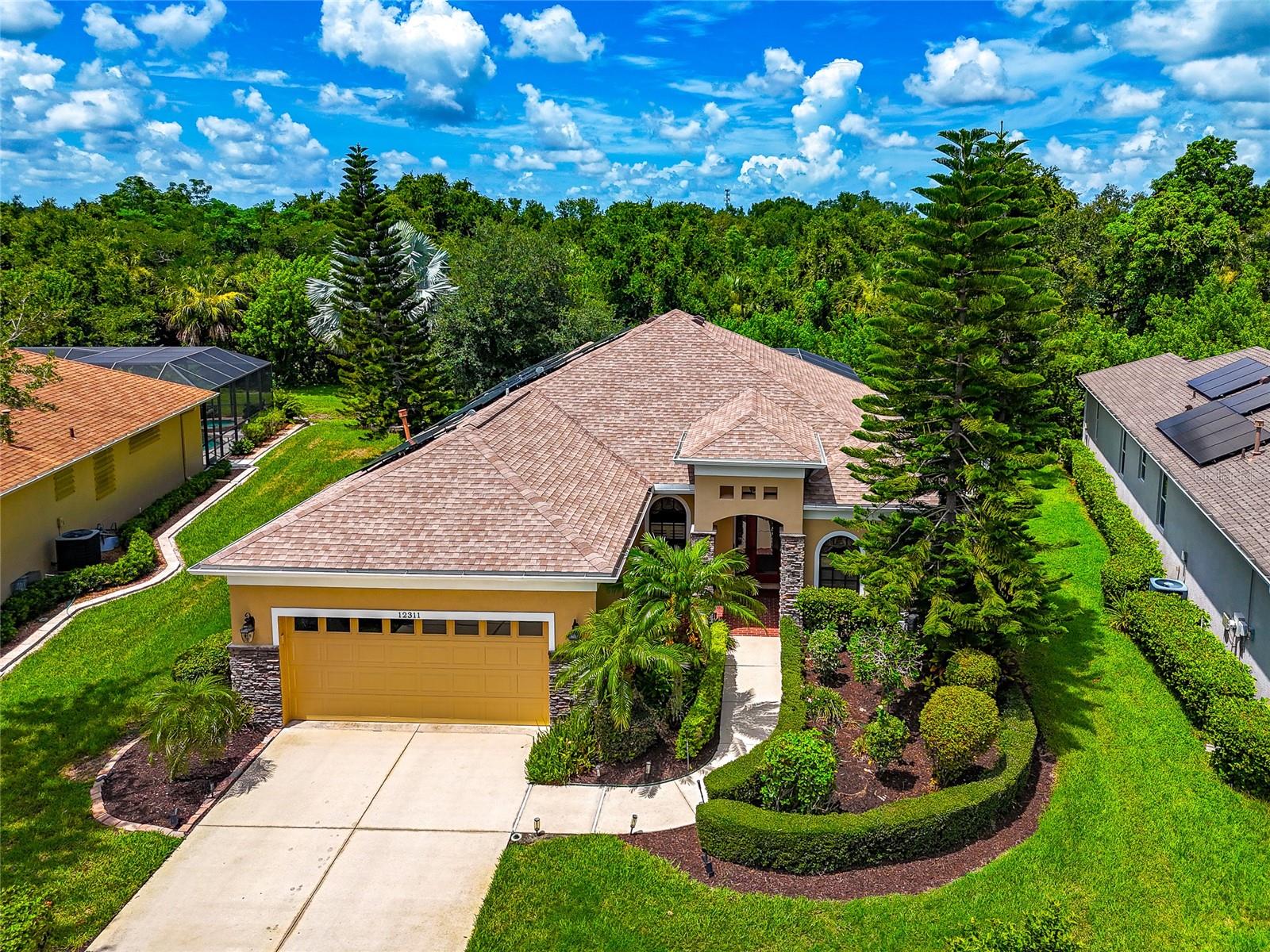 Located behind the gates of Greyhawk Landing, this move-in ready 4 bedroom, 3 bathroom home combines thoughtful updates with a private setting and plenty of room for family and guests. Enjoy added privacy with no home directly across the street and a peaceful rear setting that provides the perfect backdrop for relaxing or entertaining.

Inside, luxury vinyl plank flooring flows throughout the home, complemented by crown molding, tray ceilings, and an open, light-filled floor plan. The updated kitchen is designed to impress with quartz countertops, 42-inch cabinetry, an induction cooktop, water filtration system, abundant workspace, and an open layout overlooking the main living areas, making it the perfect gathering place for family and friends.

Large sliding glass doors fill the home with natural light and open to the screened lanai with a sparkling pool overlooking the private backyard. The split bedroom floor plan offers privacy for family and guests, while the spacious primary suite provides a comfortable retreat.

Major updates include a newer roof, updated air conditioning system, luxury vinyl plank flooring throughout, and an electric solar system that helps reduce monthly energy costs. With all the major improvements already completed, this home is truly move-in ready.

Greyhawk Landing is one of East Manatee County's premier gated communities, offering two resort-style pools, a fitness center, tennis and basketball courts, playgrounds, soccer and baseball fields, miles of walking and nature trails, and an active lifestyle for residents. Conveniently located near I-75, Lakewood Ranch, shopping, dining, top-rated schools, and the Gulf Coast's award-winning beaches, this home offers the privacy, updates, and Florida lifestyle today's buyers are looking for.