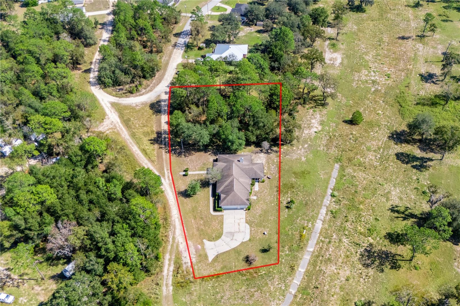 Seller offering a credit toward a new roof
Lovingly maintained 3-bedroom, 2-bath home tucked at the end of a quiet dead-end road, offering outstanding privacy and beautiful natural surroundings. This property includes the main homesite plus an additional wooded 0.31-acre lot next door, preserving the tranquil setting and providing extra space or future opportunity.

Enjoy wide, unobstructed views of the open grounds of the former golf course—no longer in service—creating a rare sense of space and serenity.

Inside, the home shines with character and care. Light-filled living areas flow into a cozy sunroom, perfect for morning coffee or evening relaxation. The screened porch invites you to soak in the peaceful breezes and natural views. Both bathrooms retain their classic overhead red heat lamps, a charming and functional vintage feature.

A 2-car garage plus golf cart parking ensures convenience and storage, while the brand-new water heater adds peace of mind.

Whether you’re seeking privacy, a connection to nature, or room to grow, this well-loved home is a rare find in Williston Highlands—ready for its next chapter!