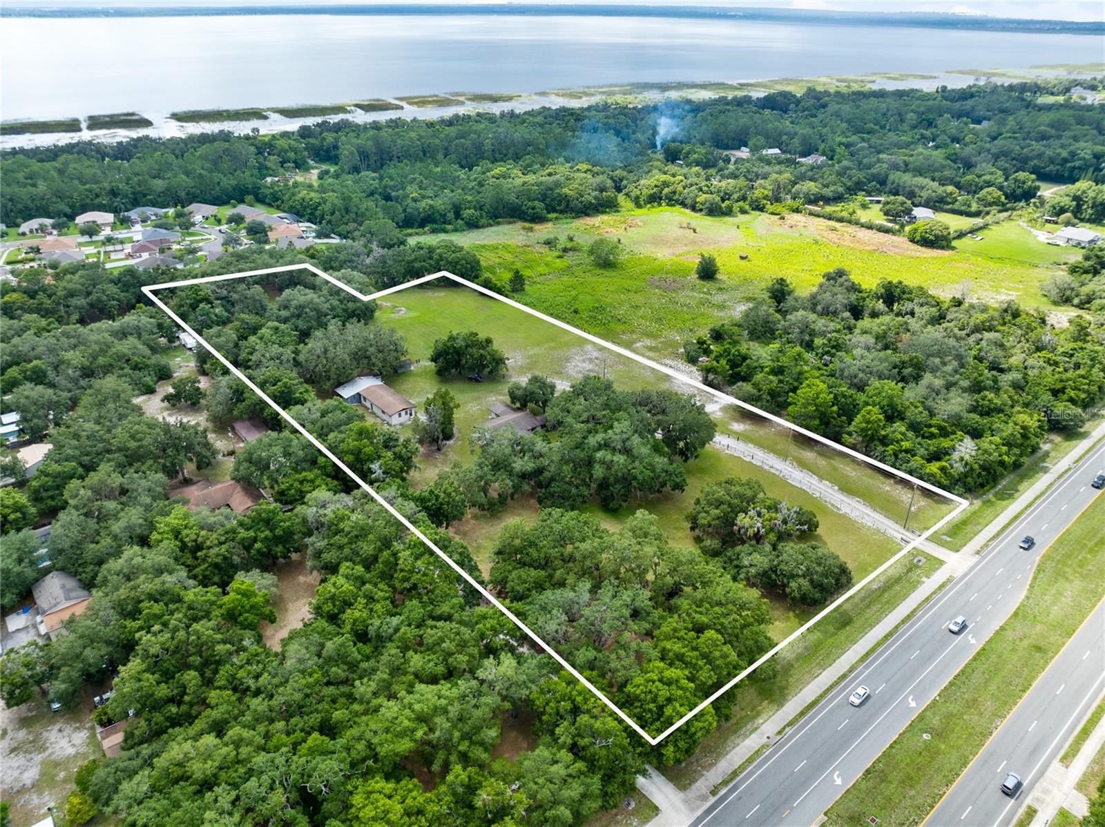 Under contract-accepting backup offers. This 7.1+/- acres is on the market for the 1st time ever!  The value is in the land on this "one of a kind property" that features a SFR and detached workshop.  With over 360ft frontage on Narcoossee Rd, close proximity to City utilities, and in Flood Zone X, this property is in high demand.  DOT count of 27,000 vehicles daily.