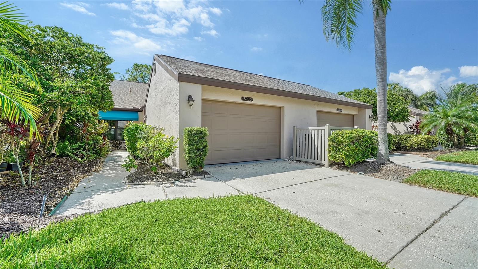 Brand new HVAC system just installed! This 2-bedroom/2-bath villa lives like a single-family home with its oversized garage. The great room floor plan with vaulted ceilings is light and bright. New dining area light fixture, ceiling fan, new sectional sofa, rugs and flat screen TV have been added for the buyer. The kitchen has an eat-in space, granite counters, pantry closet and loads of storage with a breakfast bar open to the great room. The primary bedroom with walk-in closet and ensuite bath is located in the rear and the guest bedroom and bath are located in the front of the villa for maximum privacy.  Both bedrooms have elegant luxury vinyl flooring. The updated primary bath has dual sinks and a glass enclosed shower. The year-round air-conditioned Florida room can be used for a den, office or 3rd bedroom. Impact glass windows were installed in the primary bedroom and kitchen for peace-of-mind. The garage has room for a car and a golf cart and has a new hot water heater and plenty of storage. The newly renovated community pool with spa is just a few steps away. Clubside is conveniently located close to UTC Mall with its shopping and restaurants and downtown Sarasota with its cultural venues. This small community features low monthly maintenance fees that include cable TV/internet, lawn maintenance, reserves for roof and exterior paint, trash and insurance. Benderson Park is nearby, and beaches are about 8 miles West. Enjoy the Florida lifestyle with an optional golf, tennis or social membership at Palm-Aire Country Club.