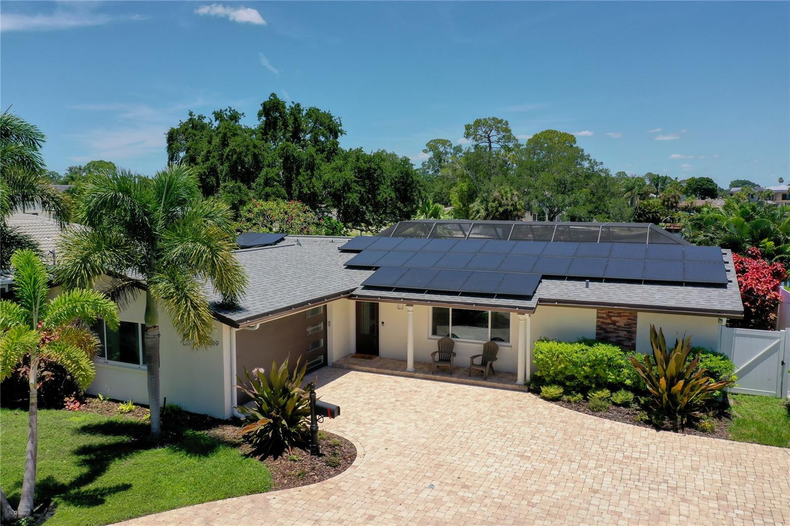 Welcome to 5119 Venetian Blvd NE, a stunningly renovated waterfront residence that seamlessly blends contemporary luxury with the relaxed elegance of coastal living in St. Petersburg, Florida. Offering 3 bedrooms, 2.5 bathrooms, and 1,712 square feet of thoughtfully redesigned living space, this exceptional home has been transformed into a bright, sophisticated retreat ideal for both everyday living and effortless entertaining.

Step inside to discover an open-concept floor plan filled with natural light streaming through expansive windows. Sleek white tile flooring flows throughout the main living areas, enhancing the home's clean, modern aesthetic. The spacious living room transitions seamlessly into the dining area and a beautifully appointed chef's kitchen, creating an inviting space for gathering with family and friends.

The kitchen is the centerpiece of the home, featuring elegant white marble surfaces, a generous center island, new stainless steel appliances, and a built-in microwave thoughtfully integrated into the custom cabinetry for a refined, streamlined finish.

The private primary suite offers a peaceful sanctuary complete with a spacious walk-in closet, dual-sink vanity, and a beautifully designed glass-enclosed shower. Two additional bedrooms and a stylishly updated full bathroom provide comfortable accommodations, each showcasing the same attention to quality craftsmanship and contemporary design found throughout the home.

Outdoor living is equally impressive. Sliding glass doors open to a screened lanai overlooking a sparkling swimming pool framed by lush tropical landscaping. Beyond the pool, a beautifully manicured lawn extends to your private dock, providing direct access to the open waters of Tampa Bay. Whether you're enjoying a morning coffee by the water, relaxing poolside, setting out for a day on the bay, or taking in breathtaking sunset views over the canal, this backyard offers the ultimate Florida waterfront lifestyle.

Additional highlights include a curved driveway with ample parking and an exceptional location just minutes from vibrant downtown St. Petersburg, The Pier, premier dining, shopping, waterfront parks, and the area's renowned Gulf beaches.

Experience the perfect combination of luxury, comfort, and waterfront living at 5119 Venetian Blvd NE—your Florida dream home awaits.