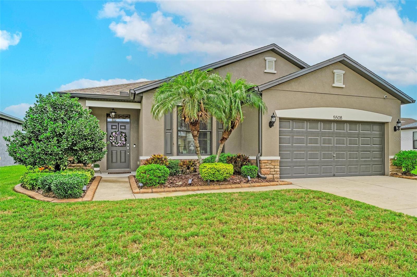 Virtually Staged. Welcome to this beautifully maintained 3-bedroom, 2-bathroom home with a den in the highly sought-after community of Harrison Ranch! From the moment you arrive, you'll appreciate the attractive curb appeal featuring stone facing and professionally installed landscape curbing. Step inside to discover a bright, open floor plan enhanced by tray ceilings, upgraded light fixtures, and beautiful laminate flooring throughout the main living areas. Just off the foyer, the flexible den offers endless possibilities as a home office, fitness room, playroom, or hobby space. The heart of the home is the well-appointed kitchen, complete with a breakfast bar, stylish pendant lighting, tile backsplash, stainless steel appliances, and cabinetry finished with crown molding. The kitchen opens up to the great room making it perfect for entertaining. The master suite is a relaxing retreat featuring a tray ceiling, an oversized walk-in closet, and a spacious en-suite bathroom with dual vanities and a walk-in shower. Step through the sliding glass doors to your screened lanai and unwind while enjoying peaceful pond views—the perfect space for your morning coffee or evening relaxation. Additional features include hurricane shutters, an irrigation system, and gutters. Located in one of Parrish's most desirable communities, Harrison Ranch offers an exceptional lifestyle with amenities that include a 24-hour fitness center, heated Junior Olympic swimming pool, 5.5 miles of scenic nature trails, tennis and pickleball courts, basketball courts, playgrounds, and an on-site activity director who organizes events and activities for both young families and active adults. The home is zoned for newer schools, including Barbara A. Harvey Elementary and Parrish Community High School. Conveniently located approximately 45 minutes from Tampa, St. Petersburg, and Sarasota, you'll enjoy easy access to world-class dining, shopping, entertainment, and Florida's renowned Gulf Coast beaches. This is more than just a home, it's an opportunity to enjoy the incredible Harrison Ranch lifestyle. Schedule your private showing today!