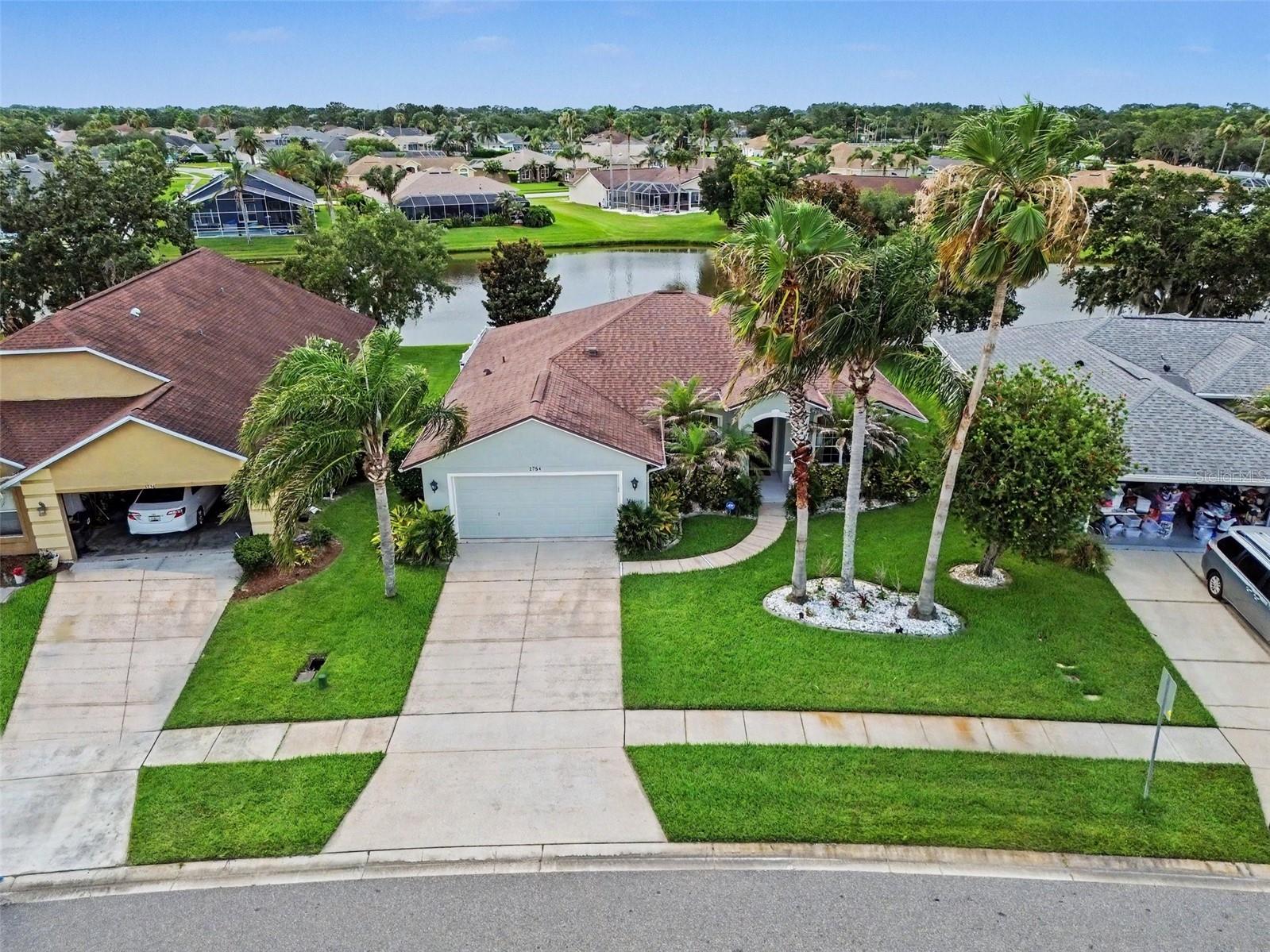 Enjoy the best of Florida living in the scenic Waters Edge community of Port Orange, where peaceful lakes, fountains, and beautifully maintained surroundings create a tranquil setting to call home. This thoughtfully designed residence offers an open and inviting floor plan with distinct living and dining spaces, plus a sunny breakfast area just off the kitchen for casual meals and morning coffee. The spacious living room opens to a screened lanai through expansive sliding glass doors, creating a seamless connection between indoor and outdoor living. Situated along a pond with fountain views, the large vinyl-fenced backyard offers plenty of space to relax, entertain, or create your own outdoor oasis. The private primary suite is tucked away from the secondary bedrooms and features a walk-in closet and an ensuite bath with dual sinks and a spacious shower. Three additional bedrooms, including one that can easily serve as a home office or study, provide flexibility for a variety of lifestyles. A convenient exterior door from the secondary bathroom to the lanai adds everyday functionality. Located just minutes from area golf courses, shopping, dining, and approximately 15 minutes from the beach, this home also offers easy access to Orlando's world-famous attractions. Experience the comfort, convenience, and relaxed coastal lifestyle that make Port Orange such a desirable place to live. Click the Virtual Tour link to view the 3D walkthrough. Discounted rate options and no lender fee future refinancing may be available for qualified buyers of this home.