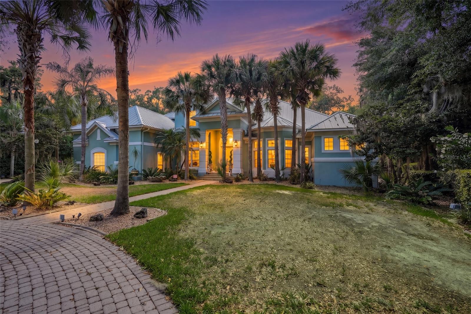 Gorgeous custom built POOL home with DIRECT LAKEFRONT on Lake Minnehaha! Set along the sparkling shores of Lake Minnehaha—part of Clermont’s coveted Chain of Lakes—this exceptional custom-built estate in the exclusive gated community of Osprey Pointe in Clermont offers an unmatched blend of elegance, comfort, and resort-style living. This stunning two-story lakefront residence features 5 bedrooms, 4 full baths, and 1 half bath, thoughtfully designed for both everyday living and upscale entertaining. Upon entry, you’re welcomed by refined formal spaces including a sophisticated dining room with custom built-ins and a formal living room that frames serene water views. The expansive primary suite on the main level is a private retreat, showcasing breathtaking pool and lake views, two oversized walk-in closets, and a luxurious spa-inspired bath complete with a spacious garden tub, walk-in shower, dual vanities, built-in makeup station, and a private water closet. A dedicated office with rich custom wood shelving sits just off the foyer, ideal for working in style. The heart of the home is a spacious kitchen featuring abundant cabinetry, stainless steel appliances, an island, bar-top seating, and seamless flow into the expansive family room with soaring ceilings, a gas fireplace, and picturesque lake views. The main level also includes two generously sized bedrooms with a shared bath, another full pool bath with walk-in shower, and a well-appointed laundry room with ample storage. Upstairs, the home transforms into an entertainer’s dream with a large loft/game room complete with a wet bar and half bath, a dedicated theater room with stadium seating, and a private gym overlooking the pool and lake. Two additional bedrooms and a full bath complete the upper level, along with extensive attic storage space that is easily accessible. Step outside to your private backyard oasis—fully fenced and highlighted by a private dock and heated, screened-in pool and spa, all set against tranquil lakefront views.  Recent upgrades enhance both beauty and peace of mind, including a standing seam metal roof (2022), fresh exterior paint (2025), pool resurfacing (2025), new pool heater (2025), and a new irrigation pump (2025). Additional features include Bahama shutters, crown molding, a circular driveway, custom garage cabinetry, natural gas for the cooktop, tankless hot water heaters and pool heater, and lake-fed irrigation. Ideally located just minutes from shopping, dining, top-rated schools, major highways, and only 35 minutes to Orlando’s world-class attractions and Orlando International Airport, this rare lakefront gem offers the ultimate Florida luxury lifestyle.