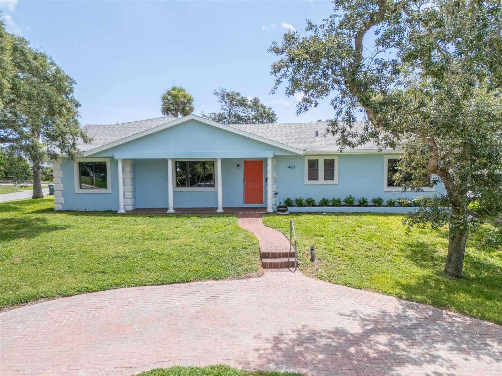 Virtually Staged. Enjoy the ocean breezes from the Atlantic just 3 blocks away. This spacious 4/3 mid century built home sits high and dry on an oversized corner lot. Plenty of elbow room between the neighboring homes.  Have a coffee on the front porch with plenty of shade from the mature trees. The back yard has ample space for a future, pool, detached garage, shed, or garden. Split bedroom plan with both the primary and second bedroom having their own bathroom. The large family room has cathedral ceilings with tongue and groove pine on both the walls and ceilings. The utility room has plenty of extra space for a freezer or general storage. Roof, tankless hot water heater and HVAC replaced in 2018.  The exterior was painted in May 2026. Irrigation system with well for low cost lawn watering.  The Beautiful beaches of Daytona and Ortona Elementary are close by.  Priced for quick sale.