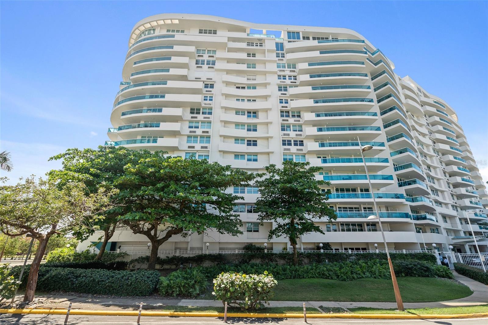 PH1608- MILLENIUM CONDOMINIUM - This unique custom designed penthouse residence showcases a modern contemporary architectural design, that offers a flawless balance of openness and natural light—designed for effortless relaxation and refined entertainment. From the moment you enter the expansive living area, panoramic 180-degree views of the Condado Lagoon and San Juan Bay unfold before you. Loft-style windows, soaring double-height ceilings, and a terrace stretching the full length of the room enhance the grandeur, while polished silver-grey terrazzo floors lend organic elegance and warmth to the modern design. A customized art-hanging system throughout the walls adds a unique gallery touch to the home.
The state-of-the-art kitchen showcases refined craftsmanship, with rich wood paneling, stainless steel accents, and natural stone countertops. This level also includes one bedroom with a full bath and a private balcony, laundry room, along with a flex room also with a full bath, providing versatile space to suit a variety of needs.
Upstairs, the second level embodies refined luxury. An open staircase of stainless steel and Brazilian wood, accented with a platform designed for art display, leads you to the master quarters. Here, breathtaking water views continue through a dramatic glass wall. The suite features a private library, walk-in closet, a serene bedroom, a spa-inspired bathroom, and its own terrace. The master level also includes one of the home’s two waterfront terraces, with a Japanese hot tub lined in soapstone—an intimate retreat reserved for the owner of this exceptional home.
Altogether, the residence offers 3,118 square feet of living space, 2 bedrooms convertible to 3, 3 full bathrooms, 2 waterfront terraces, a balcony, 4 designated parking spaces, and 1 storage unit—a rare architectural design and exceptional functionality, perfectly positioned along San Juan’s waterfront.
The condominium’s facilities further enhance the lifestyle offered, including a gym, activity room, 24/7 concierge, and valet parking service. Its privileged location places you near historic Old San Juan, across the street from Luis Muñoz Rivera Park, walking distance to Escambrón Beach, and close to museums, restaurants, a movie theater, schools, and hospitals—making it not only a luxury residence but also an unparalleled lifestyle choice.