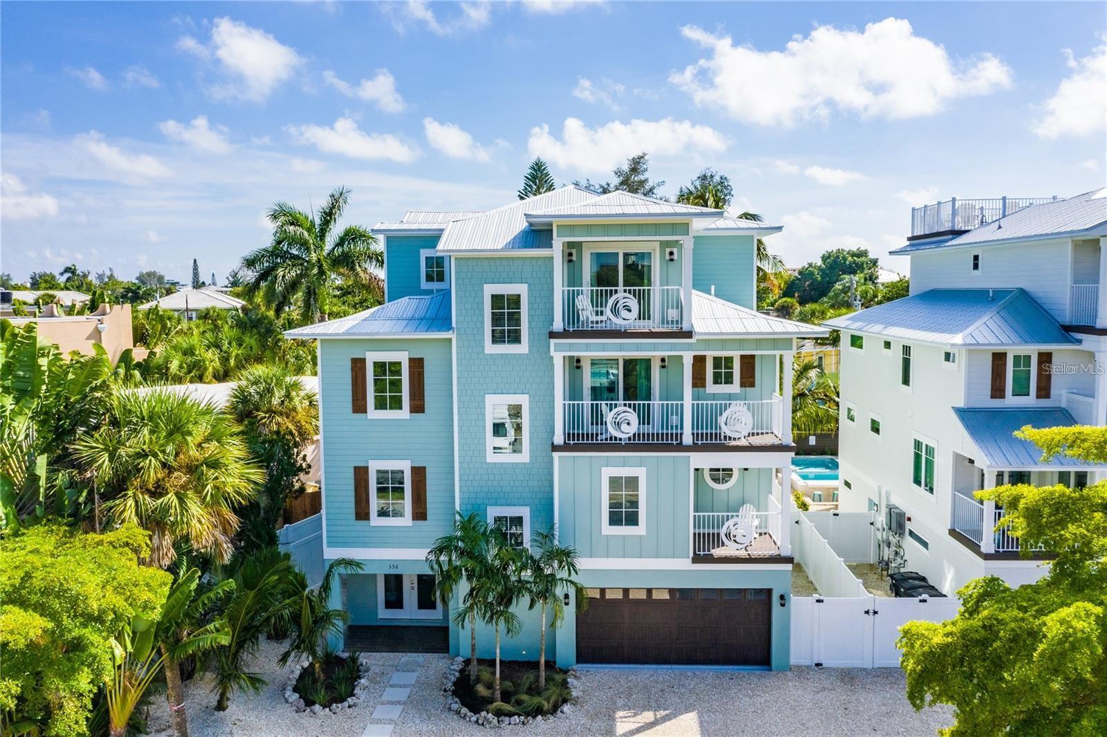Experience refined seaside luxury in this extraordinary 8-bedroom, 8.5-bathroom residence just moments from Siesta Key Beach and Siesta Key Village. Currently operating as a successful vacation rental property, this home is thoughtfully designed to maximize both guest experience and income potential. Its expansive layout, high-end finishes, and prime location make it highly desirable for short-term rentals, with ample space to comfortably host large groups.
Spanning four levels and serviced by a private elevator, the home is purpose-built for hosting. The layout includes two bedrooms on the second level, five well-appointed guest suites on the third floor—many with private baths and balconies—and a top-floor bedroom offering additional privacy. Two bunk-style rooms with a shared Jack-and-Jill bath further enhance its ability to accommodate larger parties. The primary suite provides a luxurious retreat with its own balcony and spa-inspired bathroom. The open-concept main living area serves as the heart of the home, featuring a designer kitchen with premium appliances, a large gathering island, and a dedicated bar area—ideal for entertaining. Multiple dining areas, both inside and out, create flexibility for group stays, while an upper-level flex room adds value as a game room, media space, or additional lounge area. Outdoors, guests can enjoy a private resort-style setting complete with a heated pool, sun shelf, built-in spa, and covered patio designed for comfort and entertainment. Multiple balconies and a rooftop deck offer additional gathering spaces, with sweeping Gulf views and unforgettable sunsets that consistently maximize the Florida experience. With its proven rental appeal, generous accommodations, and unbeatable location, this property presents a rare opportunity to own a **turnkey, income-producing investment** or a luxurious personal getaway in one of Florida’s most sought-after beach destinations.