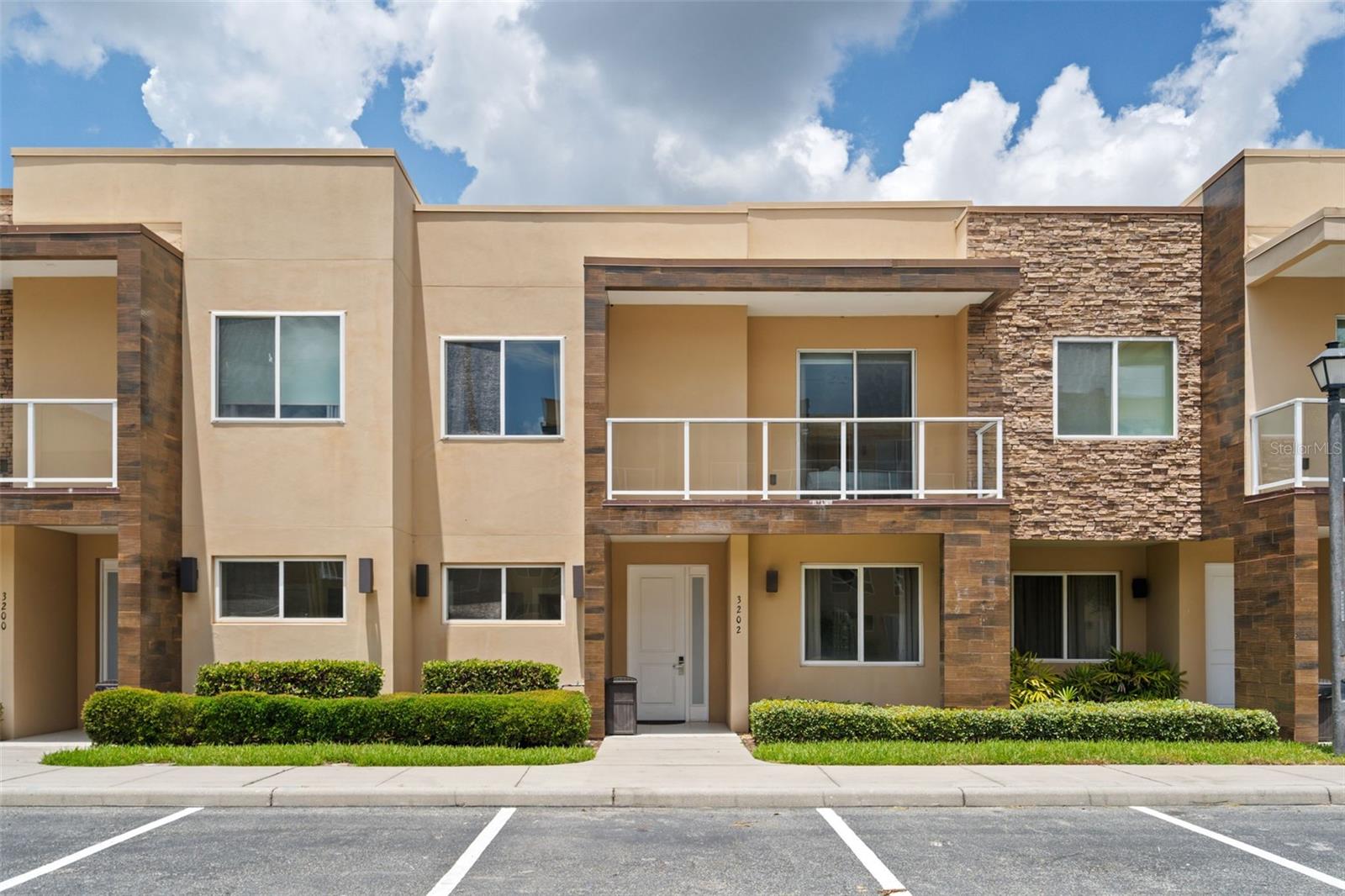 LUXURY VACATION HOME WITH ONE OF THE BEST VIEWS IN MAGIC VILLAGE RESORT! This fully furnished 4-bedroom, 4.5-bath luxury townhome offers 2,396 square feet of turnkey living just minutes from Walt Disney World. Perfectly positioned with direct clubhouse and pond views, this highly desirable residence also enjoys beautiful sunset views and one of the most sought-after settings within the community.
Designed for both personal enjoyment and exceptional rental performance, the home features four spacious en-suite bedrooms, an open-concept floor plan, high ceilings, abundant natural light, and upscale finishes throughout. The gourmet kitchen boasts granite countertops, stainless steel appliances, and custom cabinetry, seamlessly flowing into the living and dining areas. Outside, enjoy a private covered patio with a built-in grill and sink, plus a second-floor balcony overlooking the water and resort amenities.
Sold fully furnished and professionally decorated, this property is truly turnkey and ready for immediate use or income generation. Magic Village Resort is a gated luxury community offering a resort-style pool, fitness center, restaurant, concierge services, and more, all just minutes from Disney, shopping, dining, and Orlando's top attractions. An outstanding opportunity for investors and vacation home buyers alike. Schedule your private showing today and experience resort living at its finest.