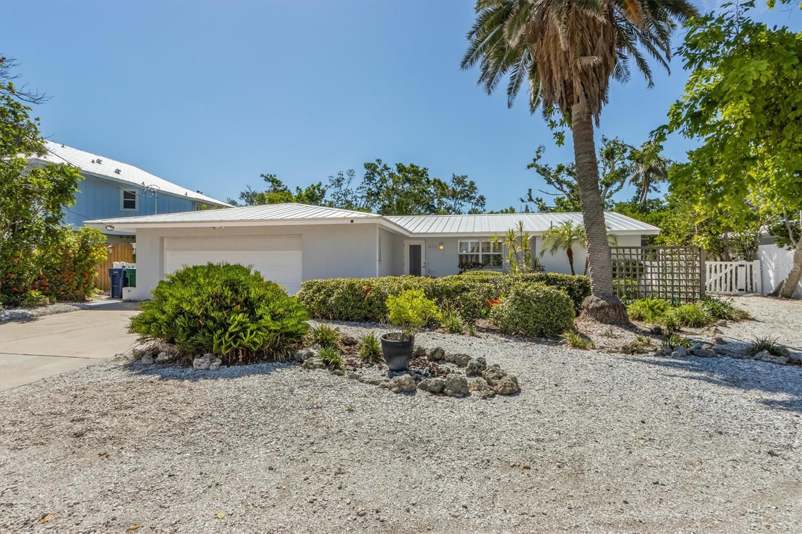 Back on the Market! Take a look at 413 Poinsettia Rd. Once you walk through the door you will be welcomed by the new fresh bright clean interior finishes.  The wall of patio doors at the rear of the home let the sunshine into the vaulted family room and open kitchen. This Is a concrete block home, with a metal roof and impact windows throughout. Its bones were not damaged during 2024’s storms. Unfortunately, water did get into the home. However, the owners did it right. Once they were able to start, their builder immediately cleaned and remediated the damaged interior. He obtained the required permits to make the home better than before. The sellers did not stop by doing just the bare minimums. While the walls of the homes were open, they replaced the electrical panel bringing it up to today’s codes. They also replaced the old cast iron sewer pipes with new PVC and installed new tile throughout the living area. The rear sliding doors were replaced with new up-to-date impact resistant panels. Once all this work was completed, the interior was renewed. All new kitchen and bathroom vanities were installed with new quartz countertops. All the appliances are new. The home was re-furnished and is now ready to move in and enjoy. All you need to do is add your own personal touches and transform this home into your own private oasis or a killer vacation rental. This home has a large, screened lanai on the rear that could be converted into a third bedroom with an ensuite bath. The room would have its own access to a secluded brick patio on the side of the house. There also appears to be room for a cozy cocktail pool at the front of the home. The property has 74 feet of deeded canal front with a 30-foot dock constructed with concrete, wood and Trex decking. This is the perfect spot to launch your kayak and maybe sail with the manatees who visit out back. (Check out the photos) The dock gives access to your boat lift, nestled in the mangroves that provide privacy from the water. Should you want to play in the sand, the Gulf Beach is about 500 steps away and the Bay Beach is about 200 steps from your door. Today’s home buyers need to be aware there are many homes on the island that were remediated after the storms with no building permits. City’s Code Enforcement is identifying them one by one. The homeowners will be required to apply for a “permit after the fact”. Do not get caught buying an unpermitted home. This could cause you problems in the future. This does not affect this home. Call to see this beautiful gem on the north end of Anna Maria. It will not last long. Note: also available for sale is the owners 2009 Scout 201 bay boat with a 150HP Yamaha outboard.