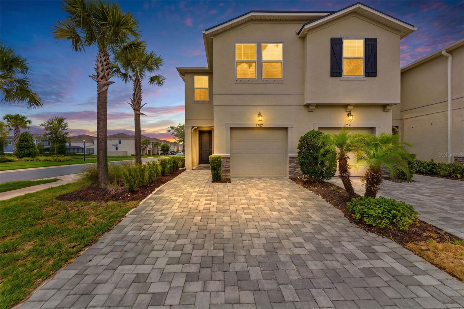 Welcome to luxury, maintenance-free living in this absolutely stunning, practically brand-new end-unit townhome (built in 2023) located in a premier gated Lutz community! Spanning 3 bedrooms, 2.5 bathrooms, and a 1-car garage, this home impresses from the moment you pull up to the brick-paver driveway and elegant entryway.  Inside, the open floor plan is bathed in natural light, showcasing gorgeous ceramic tile flooring throughout the downstairs and high-end luxury vinyl plank flooring upstairs, with plush carpet limited to the bedrooms. The contemporary chef's kitchen features bright white quartz countertops, a large island with a breakfast bar, timeless subway tile backsplash, and custom gold-accented cabinetry pulls that perfectly match the custom pendant lighting and ceiling fans. Equipped for the tech-savvy renter, the premium appliance package highlights a Samsung Bespoke® Refrigerator with an AI Family Hub screen, AI Vision Inside, and a dual-access Beverage Center, complemented by a smart oven and dishwasher.  The main living space opens seamlessly to a fully covered and screened-in lanai, perfect for relaxing. Upstairs, a versatile loft space leads to the expansive master suite, boasting two walk-in closets and an en-suite bathroom with dual quartz vanities and a walk-in shower. The secondary bedrooms are generously sized and also feature large walk-in closets. A dedicated laundry room includes the washer and dryer for your convenience.  Rent includes water, and all exterior landscaping/maintenance! Residents enjoy resort-style community amenities, including a pool, clubhouse, fire pit, dog park, playground, tot lot, and lush green spaces. Situated in a non-flood zone, you are minutes from the Suncoast Parkway, top-rated schools, premium shopping, dining, and healthcare. Our application process is quick and easy, apply today!