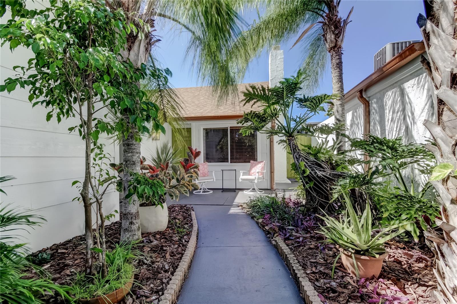 This is the one you've been waiting for! This completley high-end finished home is perfect for young professionals with a housemate, couples starting out with room for 2 children, retired couples, or a luxury vacation home or rental! Endless possibilities! Enter through a lusciously landscaped courtyard into your private oasis. The open and spacious floor plan features soaring, two-story high ceilings in the great room, kitchen, and dining room. An elegant fireplace in the family room boasts a new cedar wood hearth. Highest grade water proof laminate flooring in contemporay neutral off-white hues.  All walls and ceilings professionally finished in orange peel with S/W Emerald Paint. Interior and Exterior!  The fantastic kitchen features new cabinets, polished nickel hardware, wood floating shelves by Pottery Barn, and solid butcher block countertops. New, top-of-the-line stainless steel appliances include an Italian Forno 4-burner smooth surface cooktop and an Italian Forno oven with a microwave. The renovated primary bathroom has new shower tile, flooring, a Pottery Barn vanity, mirror, new lighting and a Kohlar high rise toilet. Very private outside shower with bench seating, the tile finishes mimic the primary bath and is on its own water heater! Enjoy a beautiful plunge pool which includes all new equipment; pump filter and SS rail. Pool has all new surface walls and floors ncluding new gunite. 2 story bronze screened lanai with built in cedar seating, landscaped feature. Finished garage with granite chip epoxy flooring and large 5x15 storage closet! Professionally pointed and painted home, new roof and fascia's, over-sized copper finished gutters and buried down spouts.  Beacon Woods is a wonderful community with low association fees featuring a community heated pool with both men and women locker rooms and private sauna, fitness center, parks, tennis courts, lighted sidewalks, Bocce courts, shuffle board courts and volley ball courts. A large community center that can be rented for parties, weddings etc. 18 hole public course with a restaurant in the community. Close to beaches, shopping, and restaurants! Seller will include the queen size primary bedroom set and the Great room sofa and two chairs with an acceptable offer. A must see!