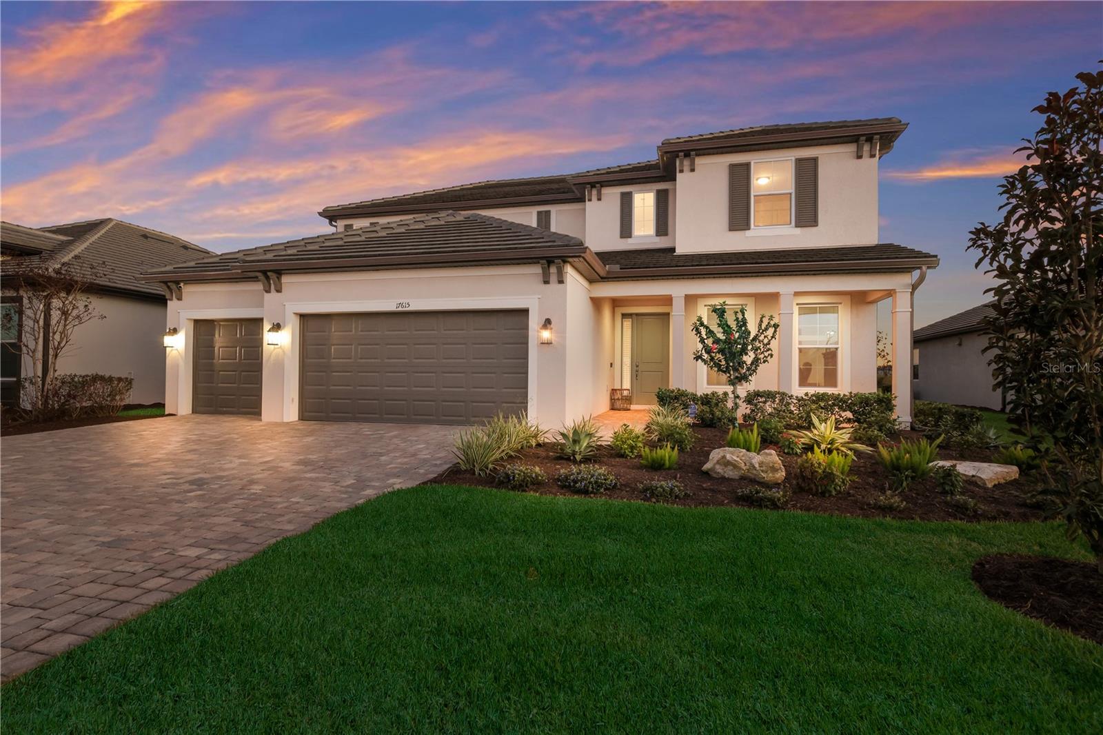 Imagine pulling into the pavered driveway of this modern home in the gated Sweetwater neighborhood of Lakewood Ranch, admiring the classic British West Indies-inspired facade and ceramic tile roof before stepping onto the inviting front porch. Meticulously maintained and nearly new, this stunning 4-bedroom, 3.5-bath Juniper floorplan by M/I Homes is loaded with upgrades and perfectly positioned on a lushly landscaped lot with southern-facing pond views and peaceful conservation in the distance. Inside, a soaring two-story foyer welcomes you, beautifully accented by custom wood trim. Just off the entry, a versatile den offers a quiet space to work from home, read, or set up a playroom. As you move further into the residence, the thoughtfully designed open layout unfolds, creating an inviting environment where daily life and entertaining flow naturally together. Picture preparing meals in the spacious kitchen, utilizing the natural gas cooktop, double wall ovens, and spacious quartz countertops while everyone chats around the island or relaxes in the adjacent cafe. For evening gatherings, you can easily pour a drink at the formal dining room’s custom dry bar, complete with a built-in wine fridge, before sitting down for dinner. Afterward, relax in the comfortable Great Room beneath the tray ceiling, anchored by a custom marble and stacked-stone fireplace wall. Slide open the impact glass doors to experience the true centerpiece of the property: a gorgeous, extended, screened-in lanai and heated saltwater pool. Here, you can spend your weekends floating beside the cascading waterfall features, hosting barbecues at the fully equipped outdoor kitchen, or watching the sunset with a cold beverage under the private pergola. Framed by tropical landscaping, privacy hedging, and peaceful, southern-facing pond views with conservation in the distance, this entire backyard feels like a personal oasis. When it’s time to unwind, the first-floor Primary Retreat offers a quiet sanctuary, featuring an elegant tray ceiling and an en-suite bath where you can rinse off in the floor-to-ceiling tiled shower or enjoy a long soak in the garden tub. Upstairs, the layout provides a separate haven for family or visitors, centered around a spacious loft ideal for game nights. Guests will feel right at home in the private suite with its own full bath, while another bedroom is already styled as a cozy home theater with a custom wood-slat wall. An additional secondary bedroom and full bathroom in the upstairs hallway round out the second floor space. Practical daily living is effortless here, thanks to a guest powder bath near the foyer and a massive Super Laundry Room that offers built-in cabinetry and a generous bonus area perfectly suited for a home gym, a dedicated pet station, or extra storage. Other notable features include: Impact windows throughout; Custom designer lighting; Custom window treatments; In-ceiling speakers; Security system on windows & doors; Epoxy floors in garage; Tankless gas water heater & more! Residents of the gated Sweetwater community enjoy access to a world-class amenity center featuring a resort-style pool, fitness center, pickleball & sports courts, a vibrant clubhouse/social hall, & more. Primely situated in Lakewood Ranch, the #1 multigenerational community in the U.S., with top-rated schools, shopping, dining & entertainment nearby, easy access to I-75, & less than 40 minutes to Siesta Key Beach & Anna Maria Island.