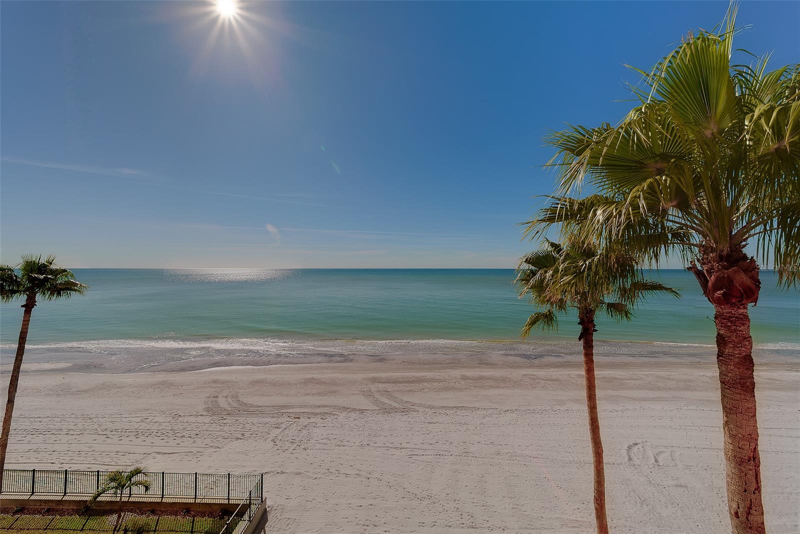 DOWN-TO-CONCRETE REBUILT IN 2022. STORM-HARDENED IN 2025. Turn-key 2BR/2BA Gulf-front at the Tides Beach Club, one of the most exclusive 10-acre gated beachfront communities in Pinellas County. Direct, unobstructed views of the Gulf of Mexico from the kitchen, living room, and primary suite, with sunset over the water every night from your full-width private balcony.

THIS IS NOT A RENOVATION. Taken down to the concrete, with a complete 100% redo of every interior finish, surface, and system above the original concrete. The only down-to-the-concrete redo in the building. Never walked on with shoes.

2025 STORM HARDENING: New hurricane-rated sliding glass doors. New impact-rated windows. New AC system. New water heater. Electric hurricane shutters on all sliders. All 2025 storm-hardening qualifies for insurance premium reductions.

2022 INTERIOR REBUILD: Full kitchen with white quartz counters, soft-close cabinets ceiling to floor, induction cooktop, hands-free waste, under-cabinet lighting, floor-level lighting, breakfast bar, full new appliance suite. Primary spa bath with walk-in shower, double vanity, and walk-in closet w/ built-ins. Guest bath with seamless glass tub/shower, new tile, vanity, fixtures. Imported Italian porcelain tile throughout. Crown molding throughout. Hard-wired for Ethernet, Bluetooth, full security system + surveillance cameras (new Guardian system installed). Plumbed for soft water treatment.

UNIT EXTRAS: Private storage closet conveniently located across the unit entrance. Under-building covered parking. Secured lobby. Pristine condition, true pride of ownership.

BUILDING-WIDE CAPITAL IMPROVEMENTS: New roof (March 2026). All new elevators (2025).

TIDES BEACH CLUB: 10-acre gated beachfront compound. Approximately 11,000 feet of private white-sand beach. FCCA Gold pilot designation (highest in Florida). 3 heated beachfront pools + 3 whirlpools. Newly renovated clubhouse with fitness center, library, billiards. 24-hour security, onsite management, gated entry. Solid HOA financials with healthy reserves.
HOA $1,448/mo includes water, trash, cable TV, internet, 24-hour security, manager, exterior + pool + clubhouse maintenance, master insurance, pest control.

LOCATION: 20 minutes to Clearwater Beach. 20 minutes to St. Pete Beach. 30 minutes to Tampa International. Walk to Sweet Sage Cafe and The Conch Republic Grill.
30-day minimum rental policy. Pets welcome.