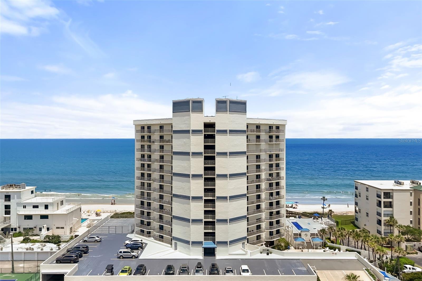 Elevate your perspective from the 10th floor of Seascape Towers. this home offers a beautifully renovated 2-bedroom, 2-full-bathroom layout that has been tastefully updated with a sleek, modern aesthetic. The highlight of this high-rise residence is its full oceanfront frontage, delivering panoramic views of the Atlantic Ocean from a height you will want to brag about. The contemporary kitchen features premium quartz countertops, seamlessly blending style and functionality. Step outside onto the private balcony to enjoy unobstructed, bird's-eye views of the sparkling coastline and refreshing sea breezes. Unlike many condo layouts, this unit boasts the added convenience of a dedicated full laundry room, alongside secure, covered garage parking. Seascape Towers is a meticulously maintained building offering a resort-style lifestyle with a pool, spa, sauna, shuffleboard courts, and a dedicated BBQ area. Positioned directly on the HIGHLY DESIRABLE NO-DRIVE SECTION of New Smyrna Beach, you can enjoy a quiet, car-free shore. With FLEXIBLE SHORT-TERM RENTAL OPTIONS with optional on-site property management, this modern retreat serves as a perfect vacation getaway or secondary home. Enjoy the peace of a tranquil beach setting while remaining just minutes from all the action New Smyrna Beach is famous for, including high-end dining, a vibrant nightlife, local festivals, and the dog beach. Experience elevated oceanfront living, schedule your private showing today!