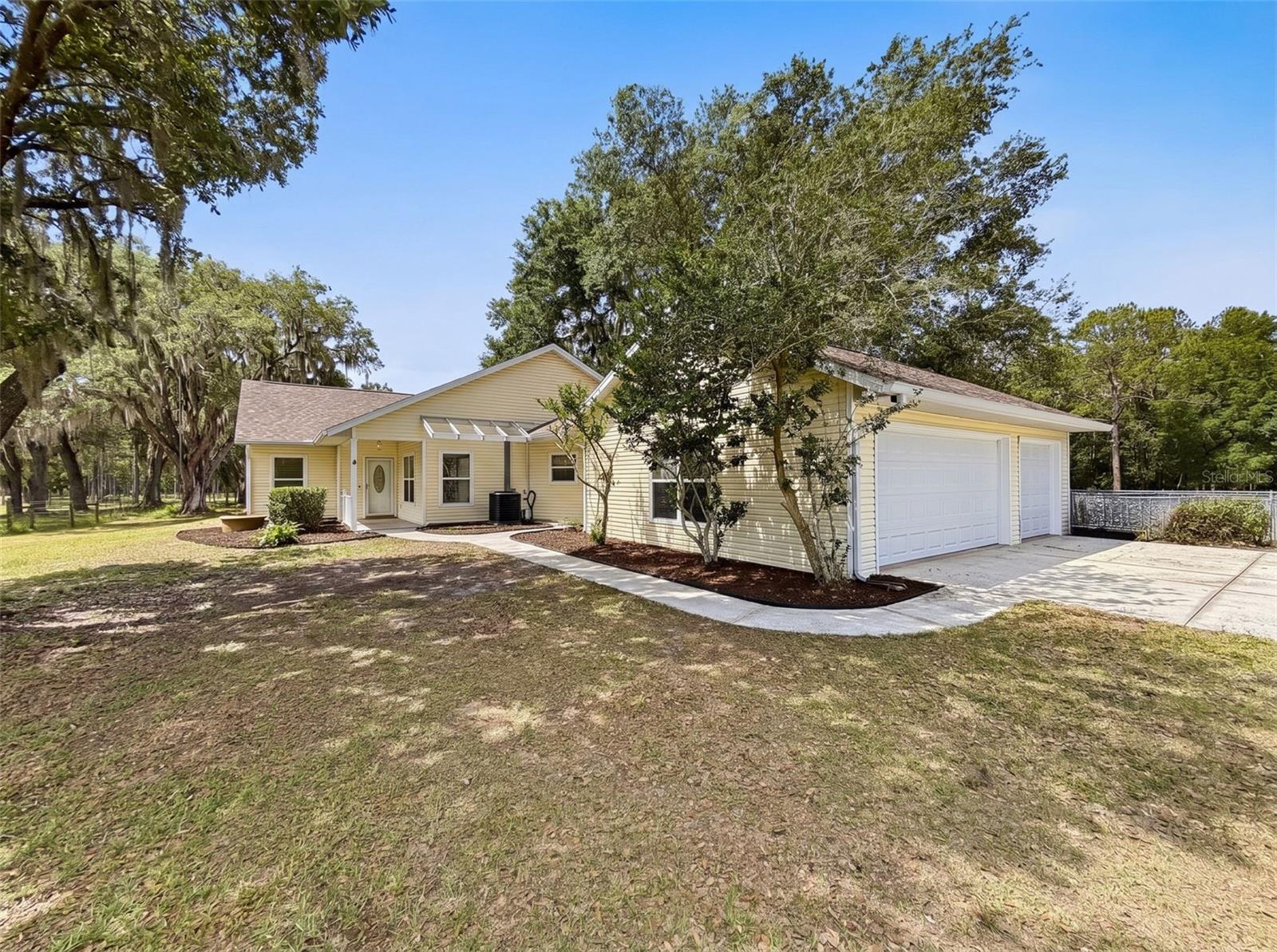 Escape to the quiet beauty of rural Brooksville with this picturesque 5-acre property featuring a beautifully maintained 3 bedroom, 2 bath home and detached 3-car garage. Surrounded by wide open space, stately old oak trees, and plenty of privacy, this exceptional property offers the perfect blend of country charm and functionality. Ideal for agricultural use, equestrian enthusiasts, grazing cattle, or simply your dream country retreat! Step inside to find a warm and inviting Great Room with a cozy gas fireplace, perfect for relaxing evenings at home. The gorgeous kitchen is sure to impress with rich wood cabinetry, granite countertops, center island, and full appliance package. A spacious Bonus Room with sliding pocket doors and wet bar offers endless possibilities and could easily serve as a 4th bedroom, game room, or entertaining space. All bedrooms are generous in size, including the spacious Primary Suite featuring an en suite bath and private enclosed sunroom retreat. Outside, the breezeway connects the home to the detached garage, which is loaded with extras including built-in kennels, grooming/bathing station, workshop area, wall AC/heat, and rear dog runs. Previously licensed for 40 dogs, the current owner operated an income-producing kennel business from the property. Three additional sheds provide even more storage and utility. The property is fenced and cross-fenced, making it ideal for animals and livestock. Lovingly maintained with numerous updates including AC (2021), Windows (2020), Roof (2024), and Garage Doors (2026). Conveniently located near shopping, I-75, and the Suncoast Parkway for an easy commute while still enjoying peaceful country living.