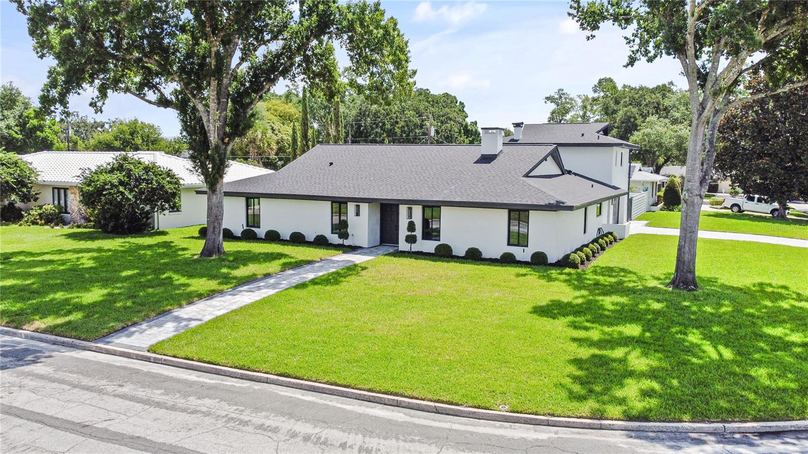 Completely reimagined and renovated, this artfully crafted stunning 5-bedroom, 4-bath residence offers approximately 2,695 square feet of on a spacious corner lot in one of Maitland's most desirable established neighborhoods. The home features an exceptional blend of modern design, luxury finishes, and functional living spaces, including a sparkling pool and expansive outdoor entertaining areas. 
Step inside to discover an impressive open-concept floor plan highlighted by wide-plank luxury flooring, designer lighting, oversized windows, and a dramatic double-sided tiled fireplace that serves as the centerpiece of the main living areas. The gourmet kitchen has been thoughtfully designed with Kitchen-aid "Black-Ore" Professional series applainces, custom shaker cabinetry, quartz countertops, a large center island, designer backsplash, butlers pantry with wine fridge, and abundant storage, creating the perfect space for everyday living and entertaining.
The spacious primary suite offers a private retreat with generous proportions, elegant finishes, and a beautifully appointed spa-inspired bathroom featuring dual vanities, custom cabinetry, a frameless glass walk-in shower, and designer fixtures. Additional bedrooms provide flexibility for family, guests, home offices, or multi-generational living.
Outdoor living is equally impressive with a screened covered lanai overlooking the newly resurfaced pool and expansive paver deck, creating a resort-style setting ideal for entertaining year-round. The large fenced backyard offers plenty of room for recreation, pets, and outdoor enjoyment.
Located just minutes from Park Avenue, Winter Park, Maitland City Centre, top-rated schools, dining, shopping, and major roadways, this turnkey residence offers luxury living in a prime Central Florida location. A rare opportunity to own a fully renovated pool home that combines timeless architecture with today's most sought-after finishes and amenities.