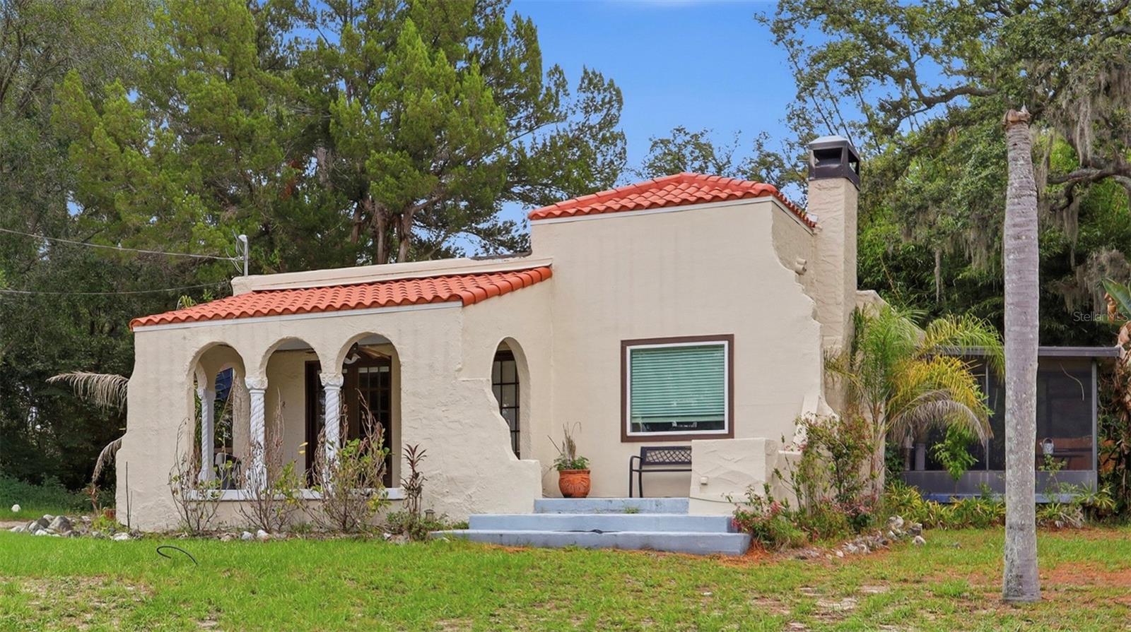 Welcome to this beautifully maintained Mediterranean-style residence nestled in the heart of Tampa. Featuring 2 bedrooms and 2 bathrooms, this charming home seamlessly blends classic architectural character with thoughtful modern updates. Roof is December 2021.

Step inside to discover warm hardwood flooring throughout, complemented by elegant arched doorways and abundant natural light that fills every room. The updated kitchen is both stylish and functional, offering modern appliances, ample cabinetry, and plenty of workspace for everyday living and entertaining.

The spacious primary suite provides a peaceful retreat with direct access to a screened lanai—perfect for enjoying your morning coffee or relaxing in the evening breeze. A large covered front porch adds to the home's inviting curb appeal and creates an ideal setting for outdoor gatherings or quiet afternoons.

Situated on an oversized lot, the property also features a versatile detached backyard structure that can serve as a home office, art studio, guest retreat, fitness room, or private flex space to suit your lifestyle.

Conveniently enjoy quick access to Busch Gardens, the University of South Florida, major highways, shopping, dining, and downtown Tampa—all within approximately 15 minutes.

Combining timeless Mediterranean charm, flexible living spaces, and an unbeatable location, this unique Tampa home offers an exceptional opportunity to enjoy the best of Florida living.