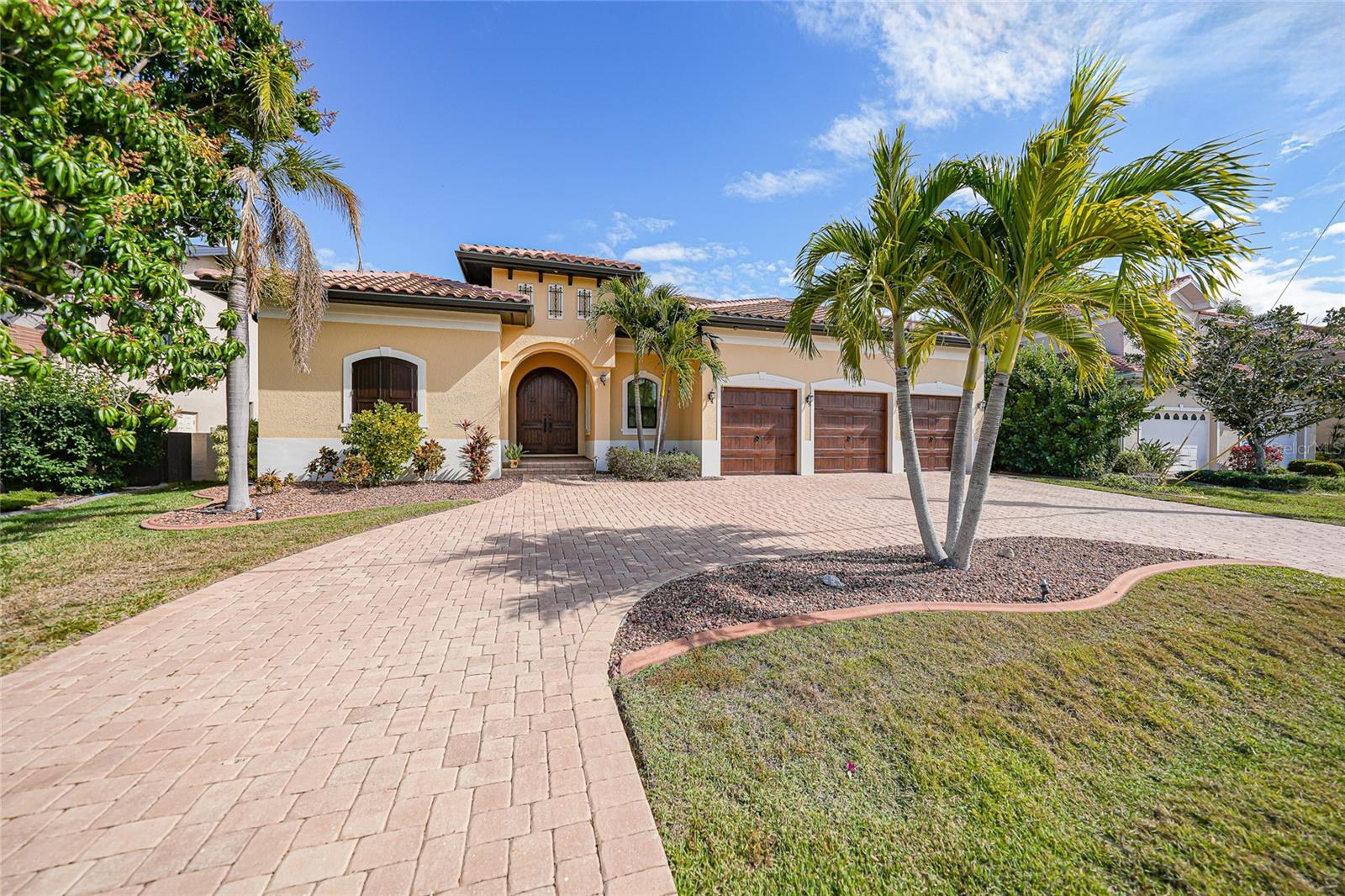 A Sail boater's Dream.
Luxury abounds in this resort-style waterfront home, perfectly situated in one of Punta Gorda Isles’ premier neighborhoods with direct access to the harbor. Boaters will appreciate the 60-foot concrete dock complete with water and electric service.  Stunning quality is evident throughout the residence, featuring a gas log fireplace in the great room, stone countertops, rich hardwood and marble flooring, and custom-painted ceilings. The air-conditioned garage adds both comfort and convenience, while every bedroom offers a private ensuite bath.
An elevator leads to the upper level, opening into a worldly Speakeasy Lounge with a fully functional bar—ideal for entertaining. The upper deck doubles as a private dance floor overlooking the water, enhanced by built-in Bluetooth speakers throughout the home.

Additional highlights include arched entryways, hurricane-impact glass windows, and an exceptional collection of rare, high-quality materials that truly set this home apart.