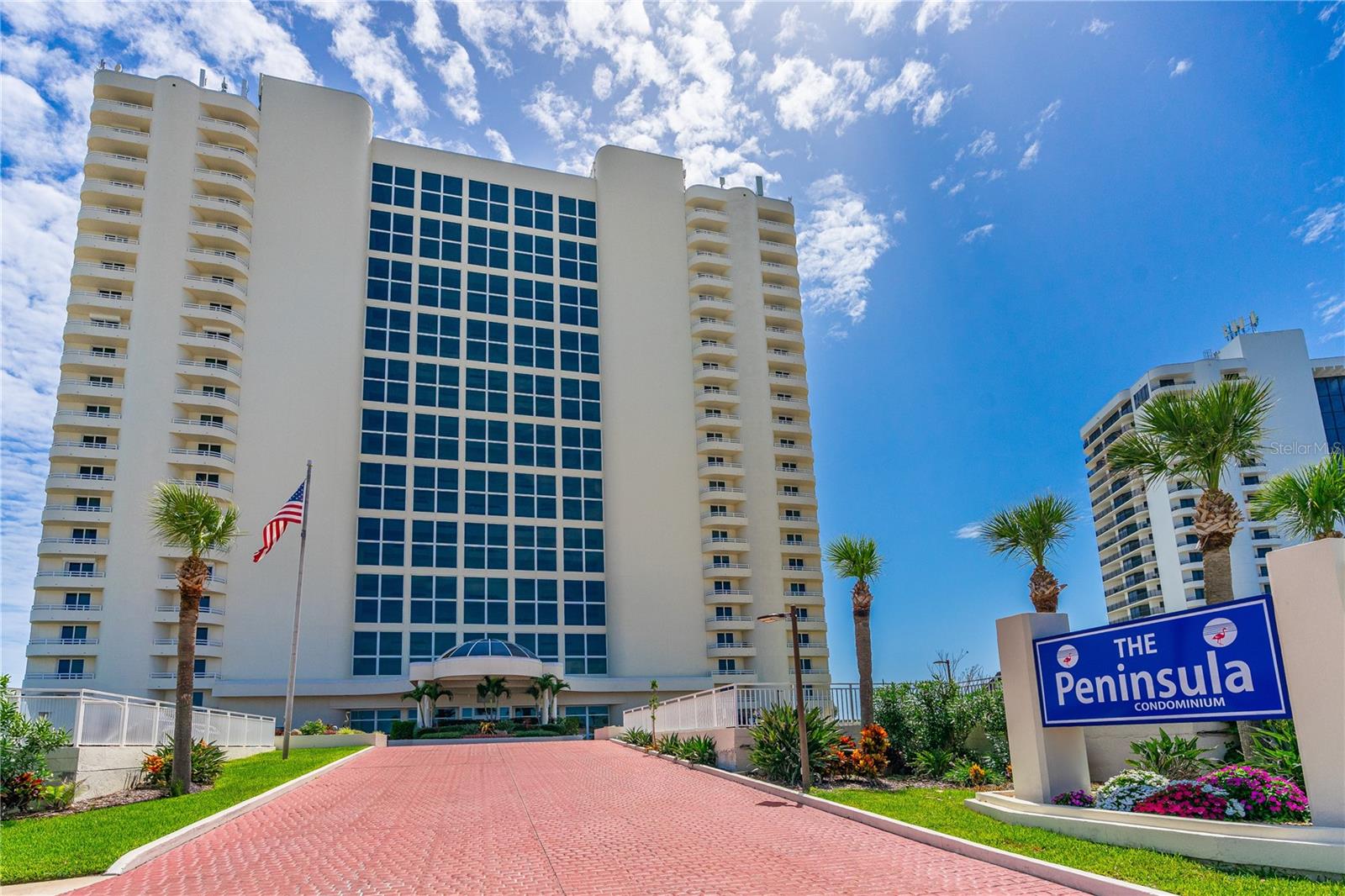 Discover the ultimate in oceanfront sophistication at The Peninsula Condominium, Daytona Beach Shores' most celebrated address—honored as the premier condominium building in the area for 2022, 2023, 2024 and 2025. This stunning, fully furnished two-bedroom, two-bathroom first-floor residence offers unobstructed, jaw-dropping Atlantic Ocean views straight from the primary suite and expansive living spaces, enhanced by peace-of-mind hurricane-impact windows and sliding doors throughout.

Inside, an airy, open-concept layout seamlessly blends living and dining areas, featuring a handy breakfast bar, a fully equipped kitchen with ample pantry storage, and the convenience of in-unit laundry. From the living room, glass sliders lead directly to a generous private patio overlooking a lush, expansive green lawn—your personal seaside oasis perfect for savoring morning coffee or unwinding with spectacular sunsets, with the beach just steps away.

Resort-style living awaits with The Peninsula's exceptional amenities: a breathtaking 23-story atrium lobby featuring an indoor river and cascading waterfall, a panoramic penthouse club room with sweeping coastal views, an indoor heated pool, a sparkling outdoor pool, a relaxing heated spa, poolside grilling areas, a state-of-the-art fitness center, billiards and ping-pong tables, a serene library, and a card room for social gatherings.

With all assessments paid, strong reserves, and recent building restorations complete, this community is in outstanding financial and physical condition. Ideally located just minutes from top shopping, dining, and the vibrant Daytona Beach Shores scene, this home embodies refined coastal living at its finest.

Rare opportunities like this don't last—schedule your private tour today and claim your slice of oceanfront paradise!