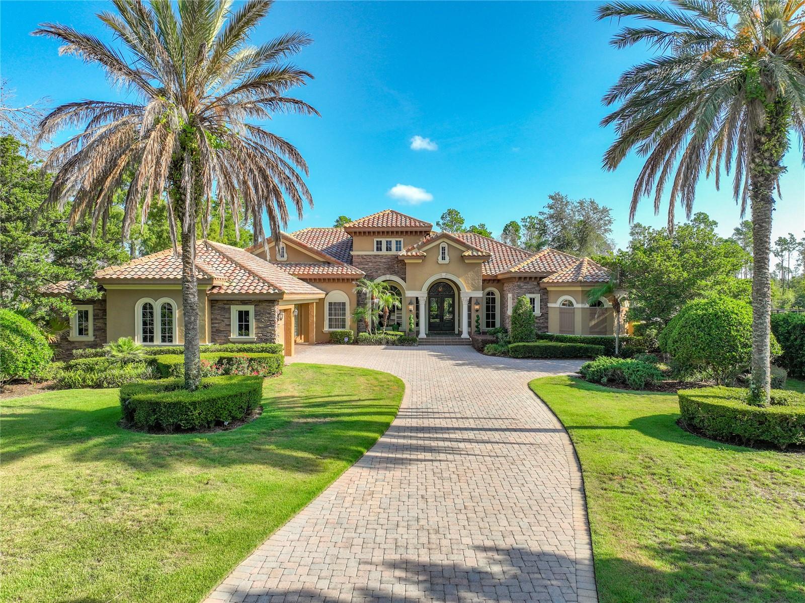Schedule a private tour today for this spectacular 5-bedroom, 4.5-bathroom home with a 3-car garage estate that seamlessly blends modern sophistication with everyday comfort. The expansive, light-filled open floor plan features striking floor-to-ceiling windows and custom zero corner sliding glass doors that frame views of your private outdoor living space. This masterfully updated estate offers a rare combination of community prestige, cutting-edge technology, and modern luxury. 
Premium Entertainment & Technology: Designed for the ultimate audiovisual experience, the home features professional-grade technology integrated inside and out:• Home Theater: A state-of-the-art entertainment room equipped with a premier JBL K2 Synthesis professional-grade home theater system.• Whole-Home Sound: A custom intercom and stereo system featuring high-performance Earthquake speakers throughout the interior.• Outdoor Audio: High-end Acoustical Resolution speakers seamlessly integrated into the patio design.
Recent Upgrades & Turn-Key Refresh: The home has been meticulously updated with premium finishes and major mechanical improvements for ultimate peace of mind:• Systems & Appliances: New full HVAC system (both interior handler and exterior unit replaced in 2025 for the primary suite), a new tankless water heater dedicated to the primary suite, a new dishwasher (2 years old), and a brand-new washer and dryer set.• Primary Suite Retreat: Completely refreshed with new flooring in the bedroom and walk-in closet, new sinks and faucets, freshly painted white cabinetry, and a beautifully remodeled shower. The expansive closet features a new statement chandelier and newly added custom, lockable display cabinets perfect for secure storage, books, collectibles and wardrobe accessories.• Interior Updates: Fresh, modern interior paint spans across the family room, kitchen, hallways, entryway, dedicated home office (the 5th bedroom), sitting room, and four bedrooms.• Upgraded Flooring & Details: New, cohesive flooring installed in the private office (the 5th bedroom), sitting room, and two secondary bedrooms. Elegance is elevated throughout with new bathroom mirrors, dining room sconces, and updated exterior coach lights. The home comes with a Tesla car charger that has multiple attachments for different EV models. Storage aplenty throughout the home. 
Outdoor Living: Step outside into your personal paradise. The screen-free transition leads to a private pool and jacuzzi anchored by an outdoor fireplace, making it the perfect setting for year-round entertaining. The property's curb appeal is enhanced by newly updated, professional landscaping. Completing this remarkable property is an generous, fully fenced backyard ready for your personal touch.
Experience Bella Collina lifestyle that has an exclusive gated 1,900-acres of rolling hills and pristine lakes. This premier community offers an unmatched gated resort lifestyle, complete with a Sir Nick Faldo championship golf course, luxury spa, fitness , pickleball, tennis facilities, and private clubhouse dining.
The community is located approximately within 10 minutes of the prominent Montverde Academy, Florida Turnpike and 45 minutes of Theme Parks.