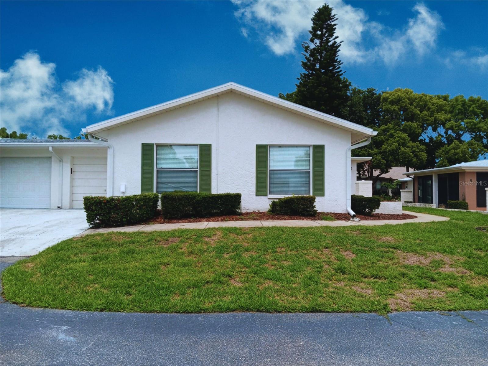 Affordable West Coast Florida Living in Timber Oaks Fairway Villas. Discover a private 1,000-square-foot oasis designed for active 55+ living. This 2-bedroom, 2-bathroom condo features an open floor plan, a 1-car attached garage, a spacious Florida room, and low-maintenance ceramic tile flooring throughout. So clean, bright, and move-in ready! Key updates include a new refrigerator and a new roof installed. As a bonus, the interior furnishings are completely negotiable separately for a turnkey move-in. Situated high and dry outside major flood zones, this pet-friendly community welcomes your small pets. The monthly $662 condo fee ensures stress-free living by covering water, trash, cable, Wi-Fi, and all exterior maintenance. Residents enjoy a world-class waterfront clubhouse packed with scheduled events, an auditorium, a heated pool, a hot tub, tennis, and racquetball and so much more (HOA $50). You are also just minutes from local beaches, public golf courses, dining, and shopping. You are going to be so happy here. Schedule your tour today!