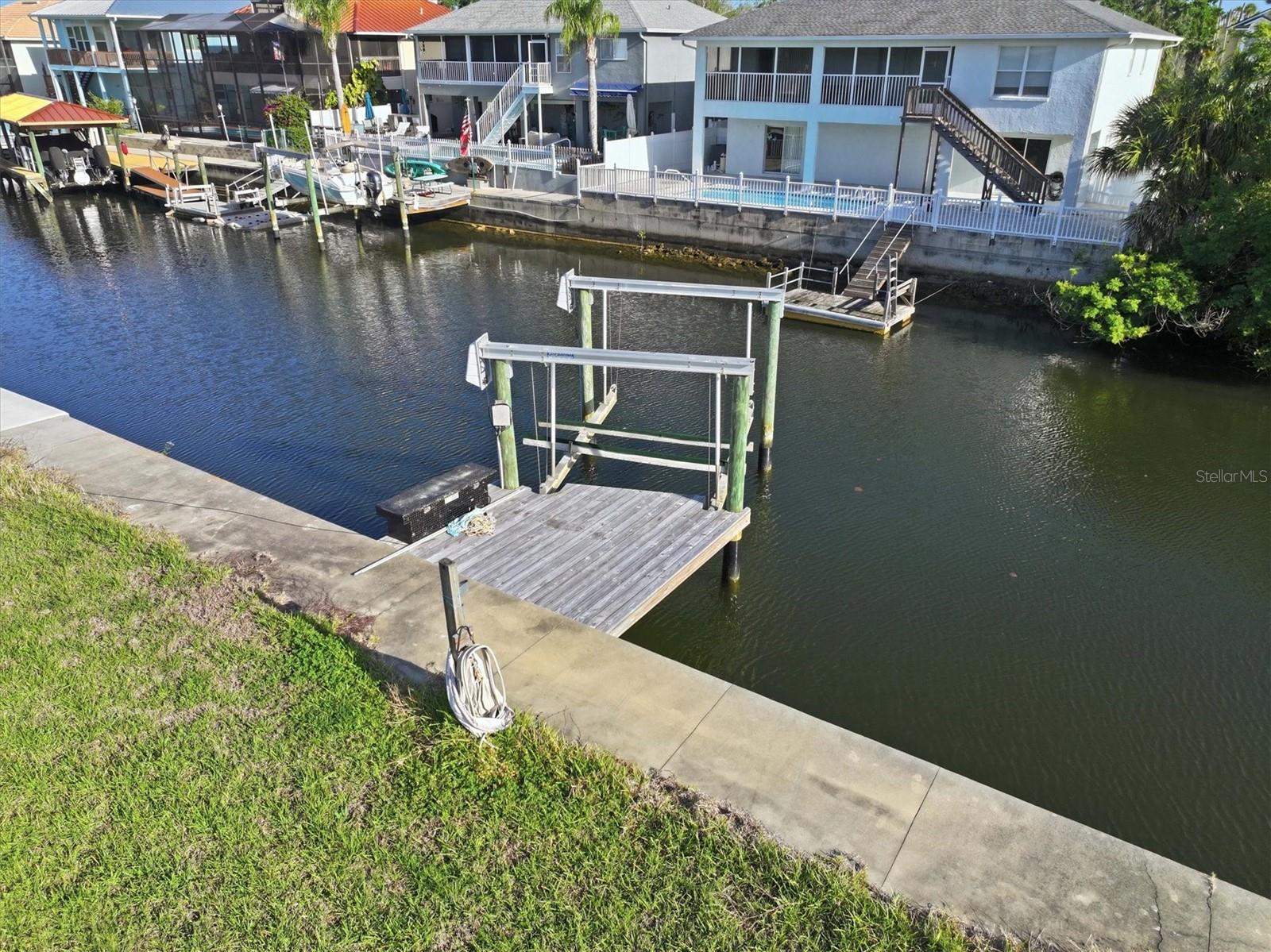 Direct Gulf Access Lot with Seawall, Dock & 10K Boat Lift – Boater’s Dream!

Live the ultimate Gulf Coast boating lifestyle with this rare direct-access residential building lot in the highly desirable Sea Pines community of Hudson. Featuring 60 feet of concrete seawall, a 10,000-pound boat lift, and existing dock, this property sits on a saltwater canal with no fixed bridges, giving you effortless access to the open Gulf of Mexico in just minutes.

Spend your days watching dolphins and manatees glide through your backyard while casting for redfish, snook, and snapper right from your property. Whether you're an avid angler or a sunset cruiser, this lot delivers the true Florida waterfront experience.

One of the biggest advantages of this property is flexibility—there’s no timeline to build, allowing you to use the lot immediately for private boat storage, eliminating the need for marina fees while enjoying instant Gulf access.

This 60 x 100 lot is already equipped with power and water, making it ready to support your boat lift and future plans.

Welcome to Sea Pines – Hudson’s Hidden Boating Sanctuary
Tucked away off Old Dixie Highway and surrounded by natural marshland, Sea Pines offers a peaceful coastal setting centered around boating and outdoor living. A Coast Guard-marked channel provides reliable, well-maintained access to the Gulf—one of the many reasons this community stands out among waterfront neighborhoods.

From your dock, explore some of the Gulf Coast’s most popular destinations:
Head south to the Anclote Key Sandbar, a local favorite for relaxing in shallow, crystal-clear water
Continue to Anclote Key Preserve State Park, an unspoiled barrier island perfect for beach days
Cruise north to the Hernando Beach Flats, a family-friendly sandbar ideal for social boating
Venture further to the Weeki Wachee, Homosassa, and Crystal River systems, known for waterfront dining, vibrant marine life, and refreshing 72-degree spring waters

Sea Pines residents enjoy access to a private community boat ramp for just $115/year, making it easy to launch and explore whenever the mood strikes. The community features an optional civic association (no strict HOA), offering freedom without sacrificing neighborhood charm.

Located just minutes from Hudson Beach, waterfront restaurants, marinas, and everyday conveniences along US-19—including shopping, dining, medical facilities, and more—you’ll have everything you need close by. Tampa International Airport is approximately an hour away, and Orlando’s world-famous attractions are just 90 minutes away.

Build your dream Gulf Coast fishing home—or start enjoying the boating lifestyle today. This is more than a homesite… it’s your gateway to life on the water.
