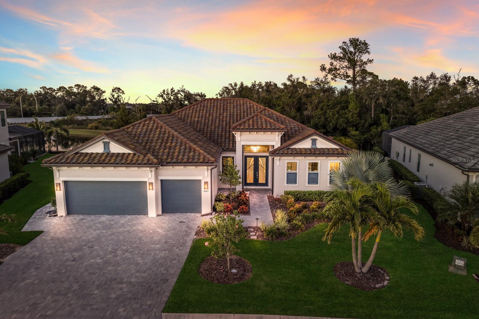 STEP into this STUNNING 3 bedroom, 3 bathroom, 3 car garage Sunset model by Lennar, located in the highly sought-after GATED community of Lorraine Lakes in Lakewood Ranch!! This home has undergone a complete REMODEL and is truly one-of-a-kind, offering MODERN LUXURY, comfort, protection, and PRIVACY with every possible upgrade you could imagine. As you step through the GRAND double front doors, you’re greeted by an ASTONISHING chandelier and ELEGANT entryway that gives you a glimpse of the home’s open concept floor plan. The living room features a beautiful COFFERED ceiling, a CUSTOM shiplap feature wall, and four panel sliding glass doors with CUSTOM SHADES for privacy that open to the lanai and pool area, creating the perfect space to unwind after a long day. The modern, UPGRADED kitchen is a SHOWSTOPPER, showcasing ceiling-to-floor cabinets with pull out drawers, pull out spice racks, a built-in oven/air fryer, gas cooktop with a STYLISH hood, modern backsplash, a walk-in pantry, a built-in coffee bar, and a large WATERFALL EDGE island with seating that’s perfect for everyday meals or entertaining guests. The cabinets extend into the dining area, which includes a wood accent wall and sliding doors offering beautiful views of the backyard. The primary suite is privately located on one side of the home, featuring sliders leading to the lanai, a tray ceiling with CUSTOM WOOD ACCENTS, two spacious WALK-IN CLOSETS, and a LUXURIOUS ENSUITE bathroom complete with dual sinks, a large tiled walk-in shower featuring two shower heads, a rain head, and a built-in shower seat for a true spa-like experience. On the other side of the home, one bedroom features a custom BUILT-IN WALL SEAT with storage, while another bedroom includes its own PRIVATE bathroom that conveniently opens to the lanai, making it perfect for use as a POOL BATH. There is also a spacious STUDY/DEN, ideal for a home office, playroom, or fitness space. The laundry room includes cabinetry, a sink, upgraded washer and dryer, and a custom built-in mudroom. Step outside to your private backyard OASIS with a fully screened lanai featuring a HEATED SALTWATER POOL AND SPA, custom WOOD CEILING, and LANAI CAGE LIGHTING that enhances the ambiance. The OUTDOOR KITCHEN comes equipped with a refrigerator and cabinets, ideal for entertaining family and friends while enjoying views of the breathtaking sunsets. For extra protection and peace of mind, this home includes MOTORIZED HURRICANE SHUTTERS on both the front door and lanai, and ATTIC INSULATION for enhanced energy efficiency. Additional upgrades include LUXURY VINYL FLOORING throughout, CUSTOM CLOSETS, PLANTATION SHUTTERS, a whole-home WATER SOFTENER SYSTEM, and a garage equipped with TRX flooring, CEILING RACKS, and CABINETRY for ample storage. The EXTENDED PAVER WALKWAY, upgraded landscaping, and outdoor lighting complete the home’s refined curb appeal. Located in Lorraine Lakes, this resort-style community offers a clubhouse, multiple community pools, a state-of-the-art fitness center, tennis, pickleball, basketball, and volleyball courts, a splash park, and even an on-site restaurant so you can enjoy Florida living to the fullest without ever leaving your neighborhood. Lakewood Ranch is known for their A+ rated school system and is perfectly located just a short ride to downtown Sarasota, St. Pete, world class shopping, fine dining and the FAMOUS Gulf beaches! Don't wait to make this your home and begin your FLORIDA Lifestyle!