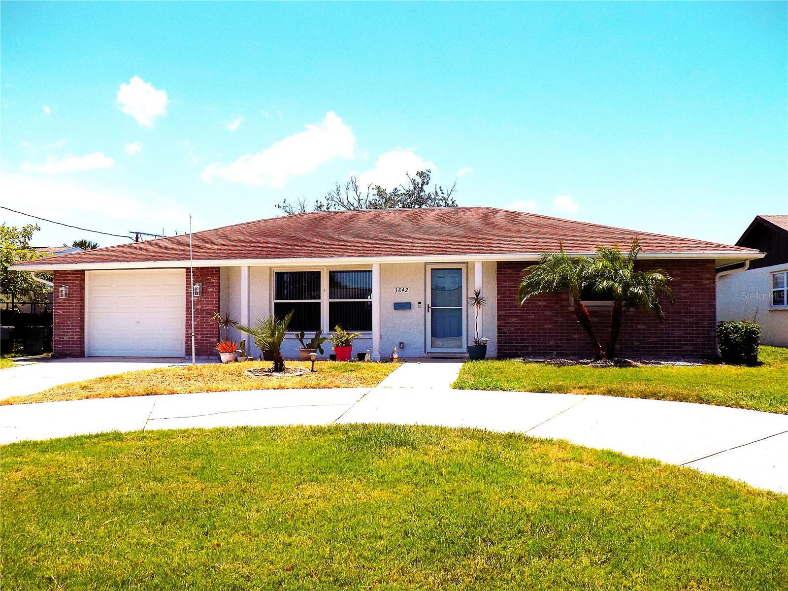 Completely remodeled POOL home located in the Flor-A-Mar community - known for its community-owned PRIVATE BEACH.  This home has a 1 car garage, newer Air Conditioner (2025), fresh paint, newer stainless steel kitchen appliances (2025), newer Washer and Dryer (2025), newer soft-touch Kitchen cabinets and soft-touch Bathroom cabinets (2025).  Check out the gorgeous granite counter-tops, modern lighted bathroom mirrors, and modern lights and fans in the bedrooms and baths.  The beautiful terrazzo floors have been restored and polished to offer a uniquely amazing, easy-care floor throughout the home.  This home features a large living space and an enclosed, air conditioned Florida room looking out on the sparkling in-ground pool, fenced in back yard and open green space behind the house.  A circular drive provides plenty of parking at this one of a kind neighborhood of (mostly) waterfront properties.